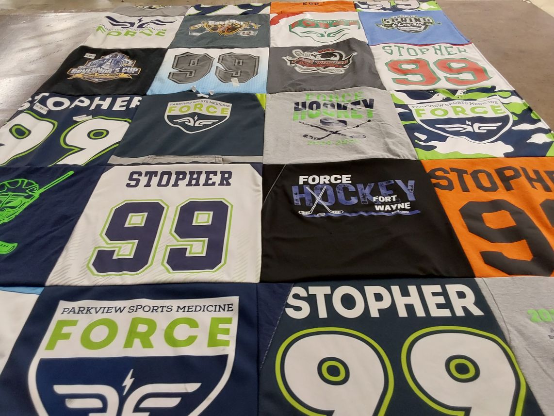 T-shirt quilt with hockey, sports themes by Kristi from IN