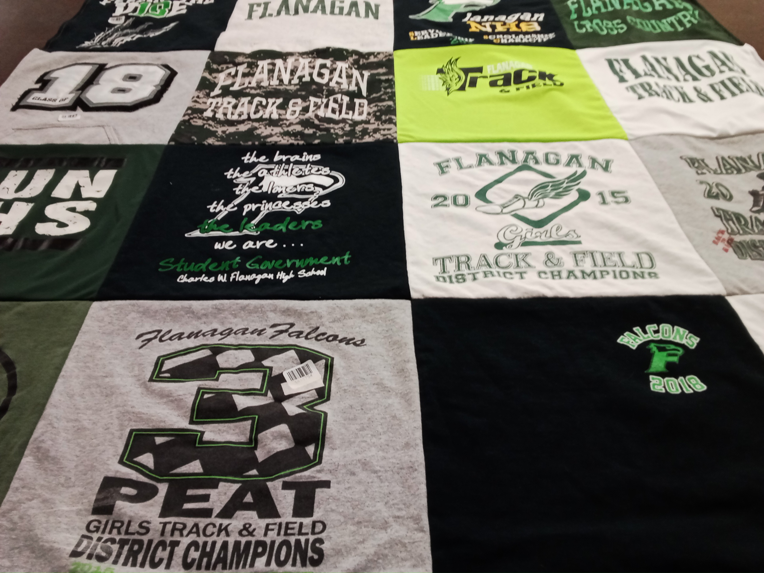 T-shirt quilt featuring flanagan falcons track and field, flanagan falcons cross country by Megan from FL