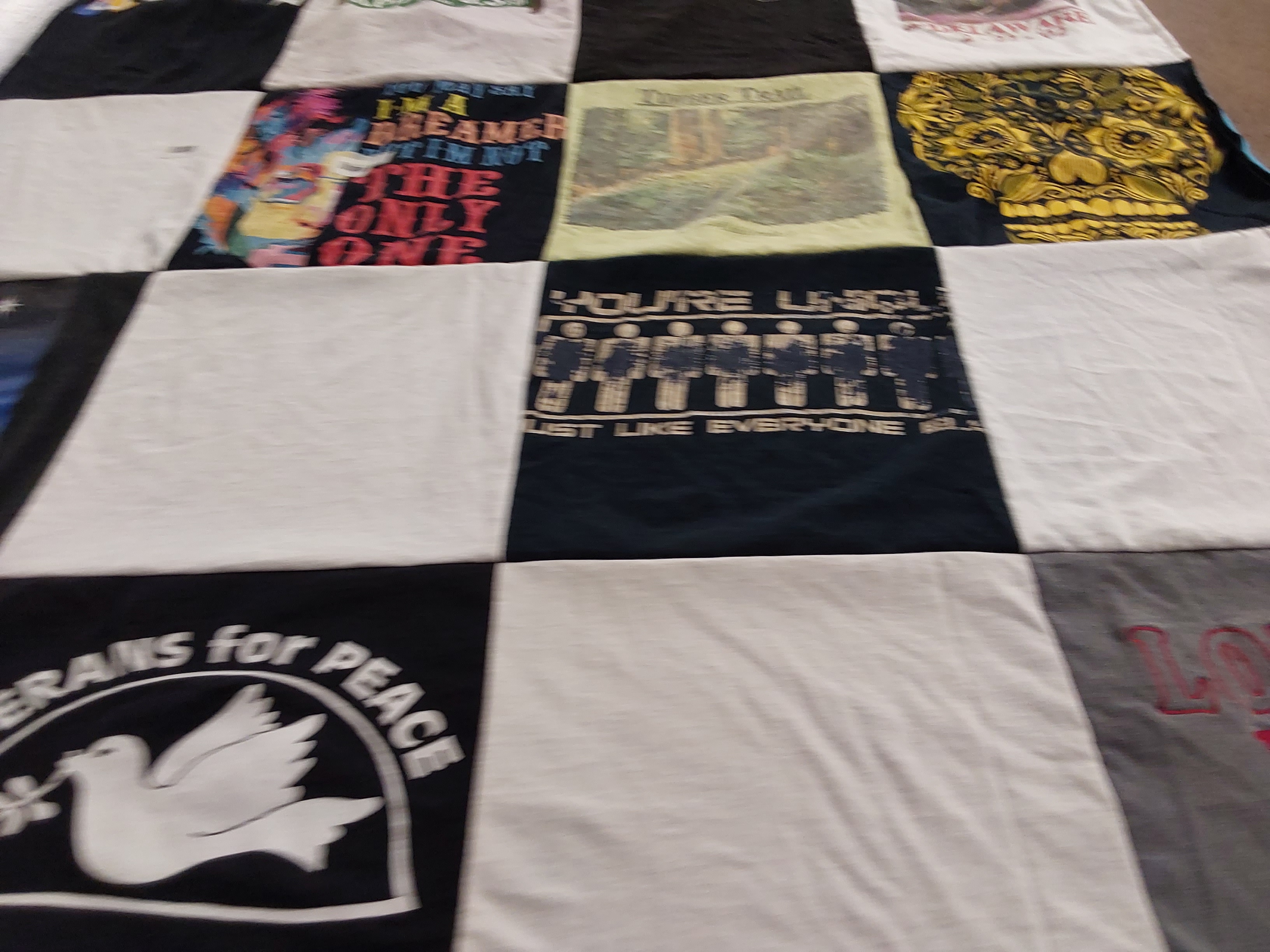 T-shirt quilt with peace activism, music themes by Julie from CA