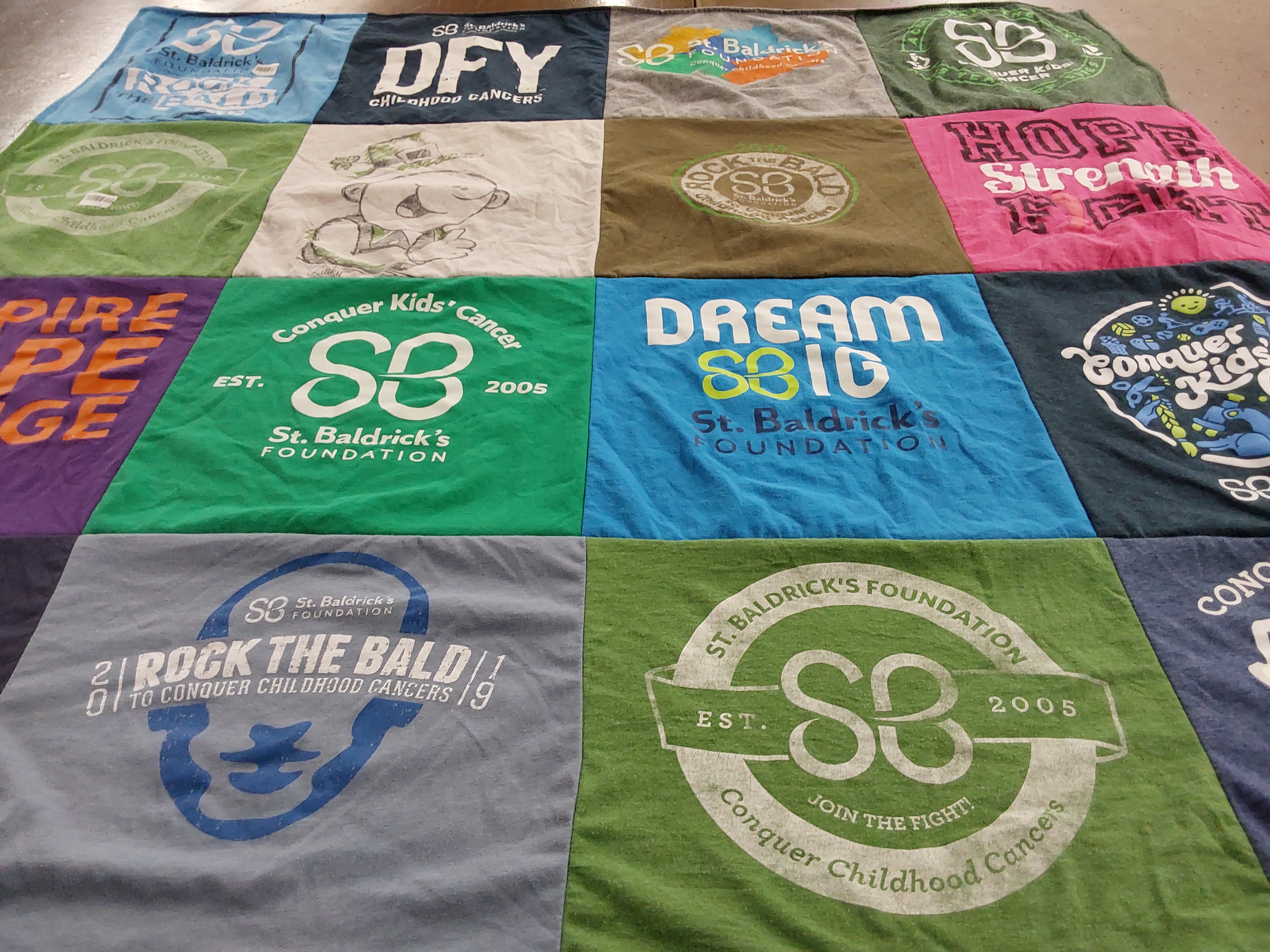 T-shirt quilt with childhood cancer awareness, fundraising themes by Carol from NJ