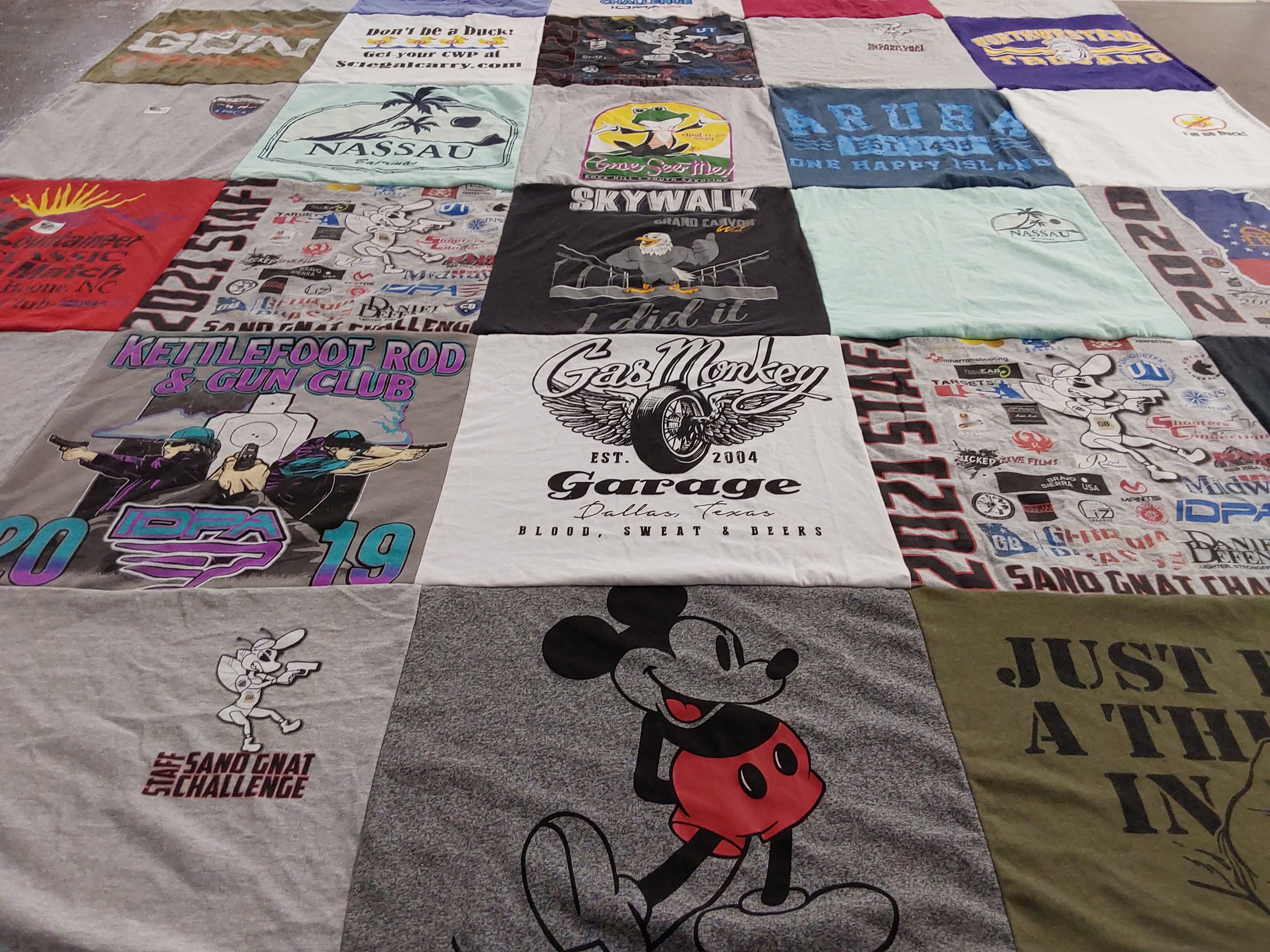T-shirt quilt with fishing, firearms themes by Michelle from SC