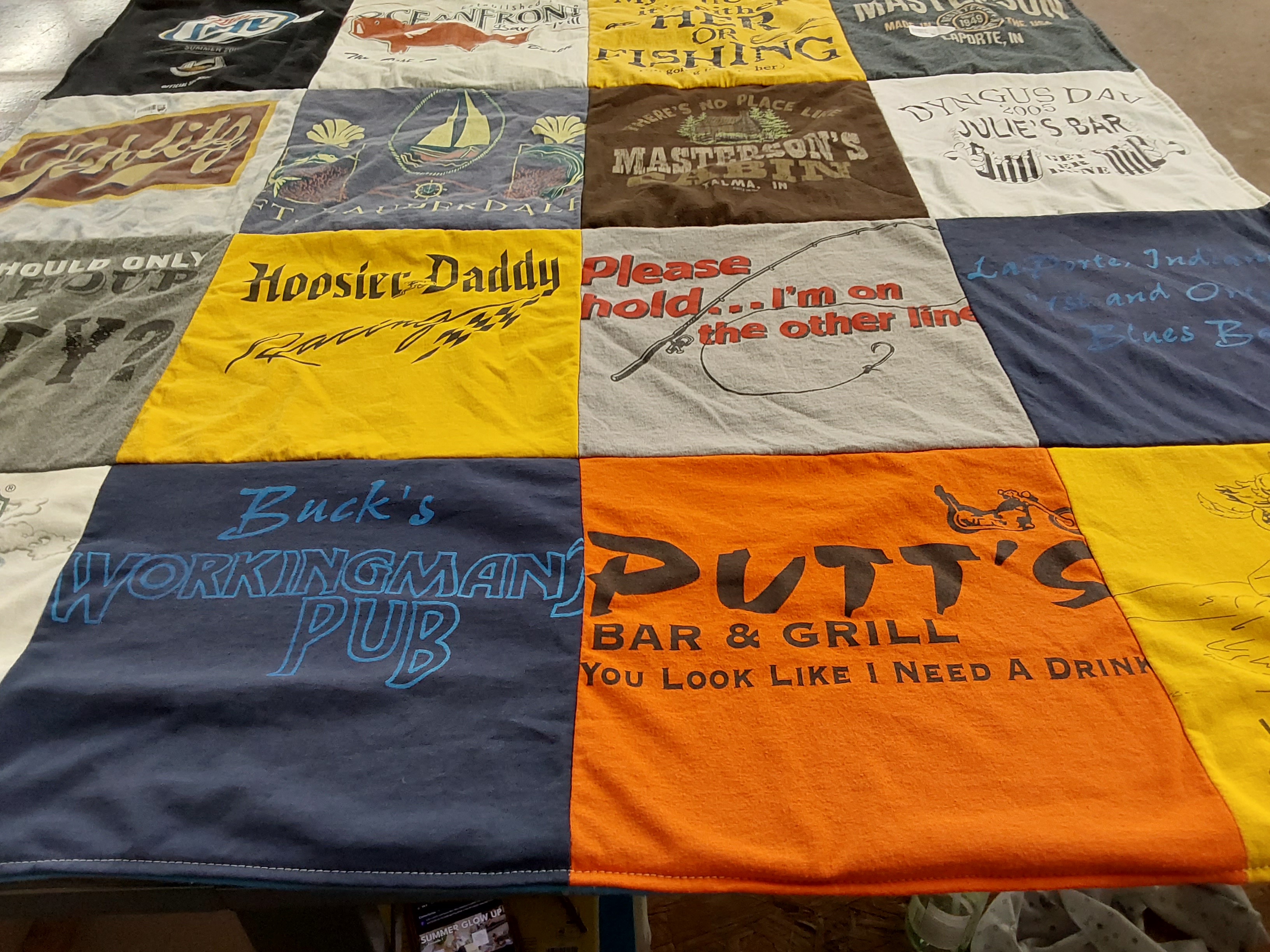 T-shirt quilt with fishing, drinking themes by Janice from IN