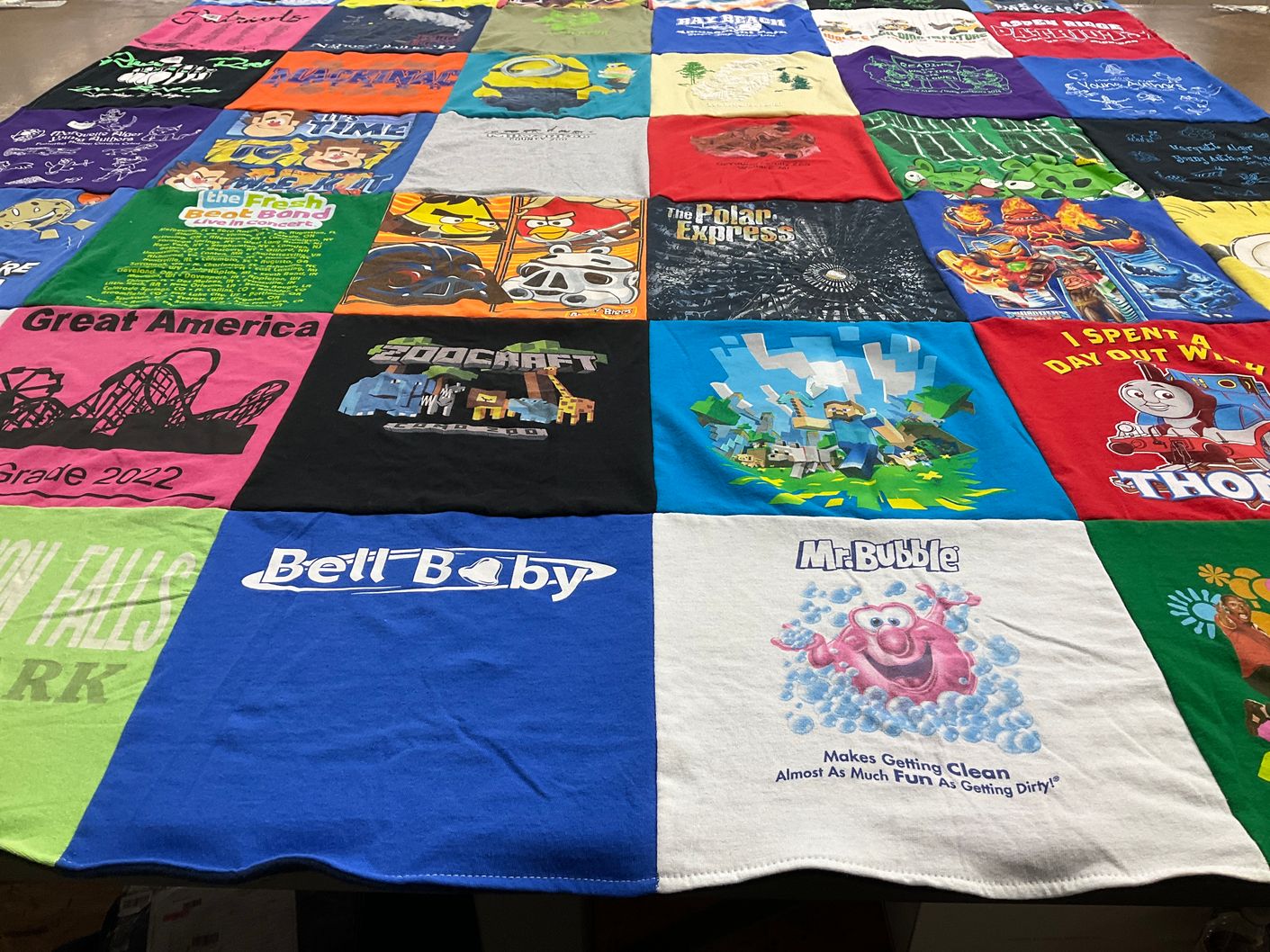 T-shirt quilt with amusement parks, cartoons themes by Becky from MI