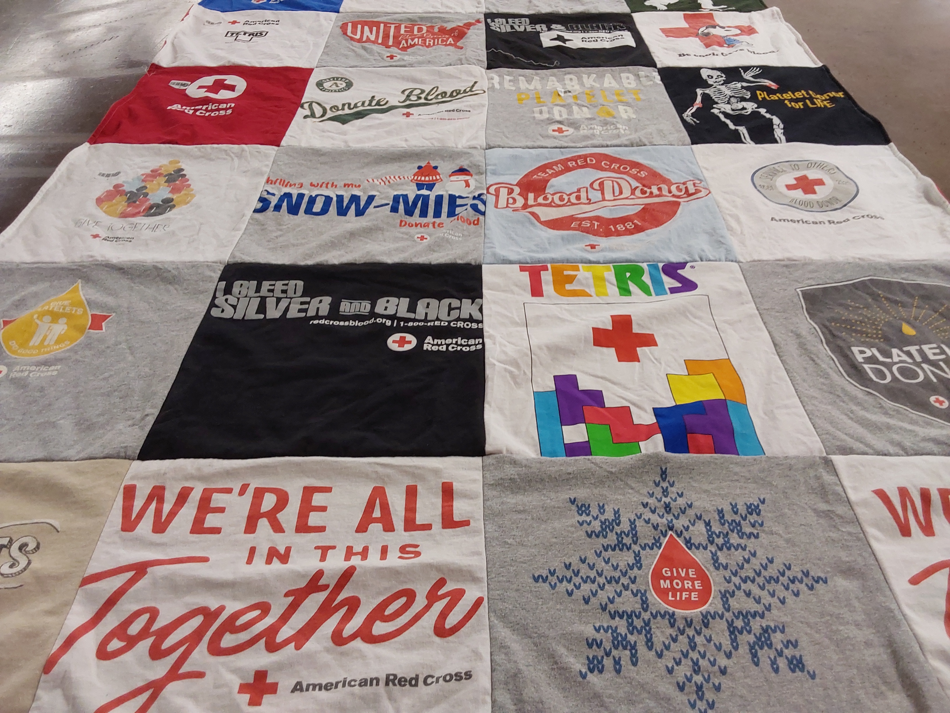 T-shirt quilt with blood donation, community support themes by Gina from CA
