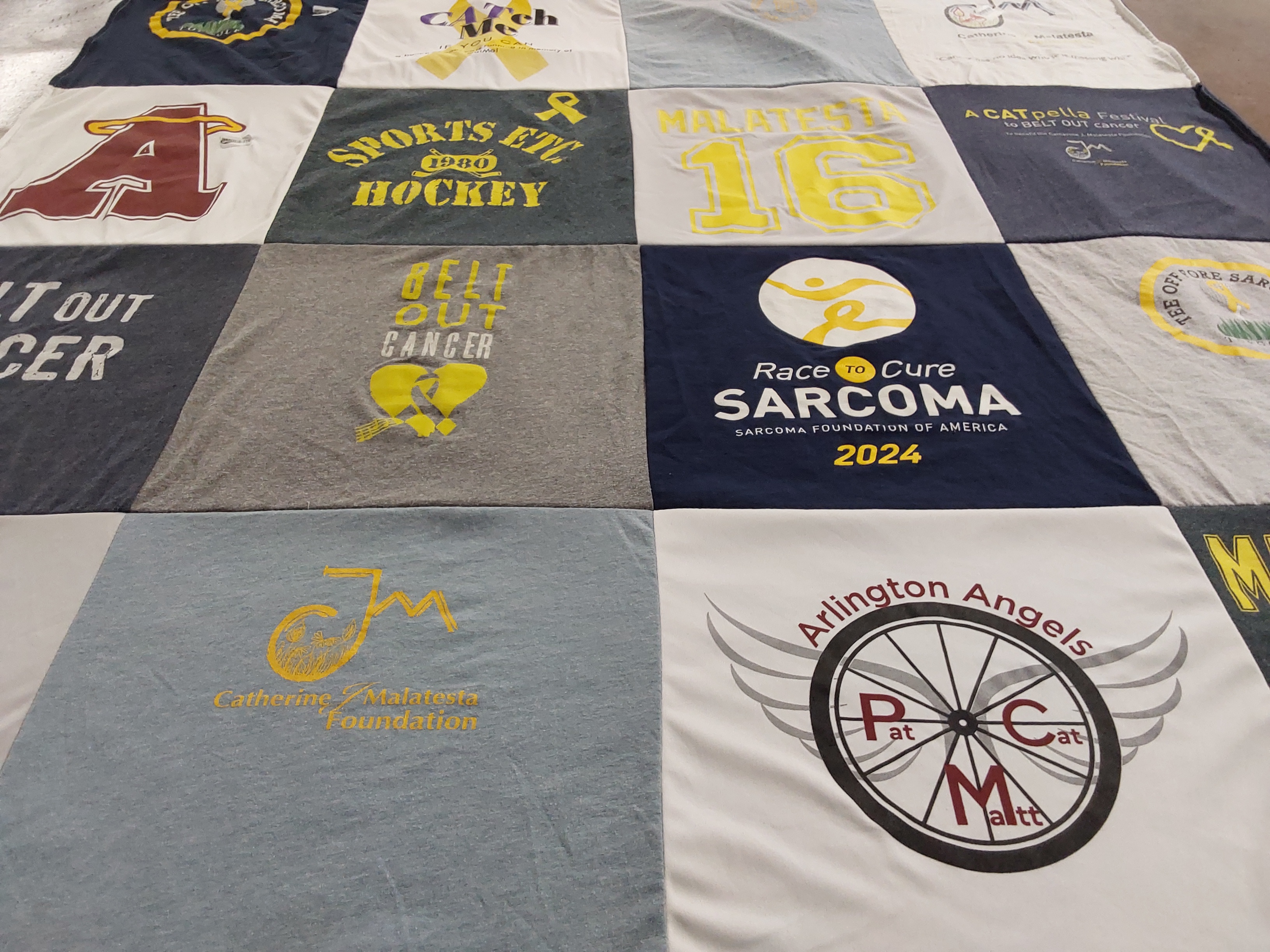 T-shirt quilt with cancer awareness, sports themes by Kathryn from MA