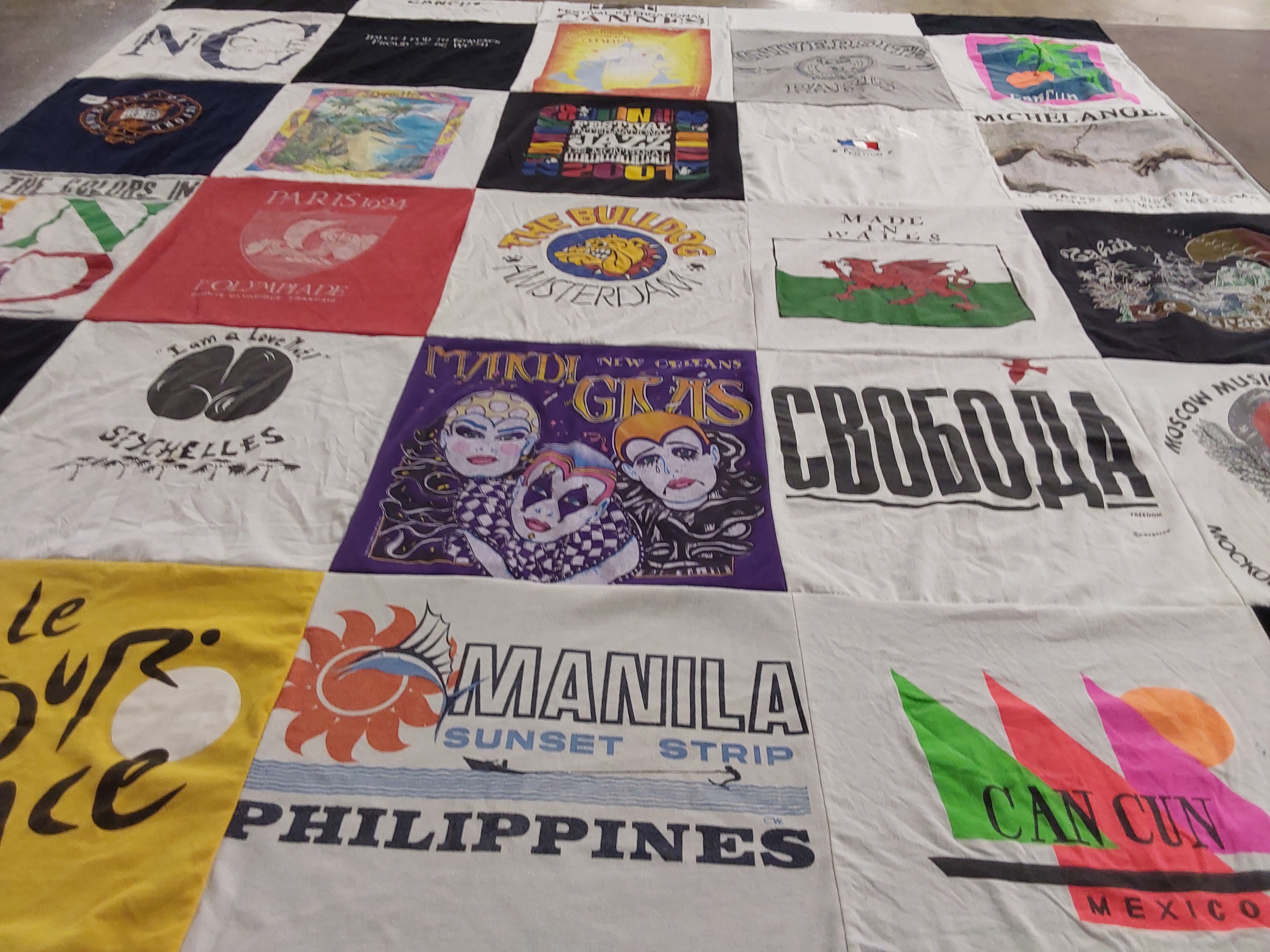 T-shirt quilt with travel, cultural festivals themes by Mary from CA