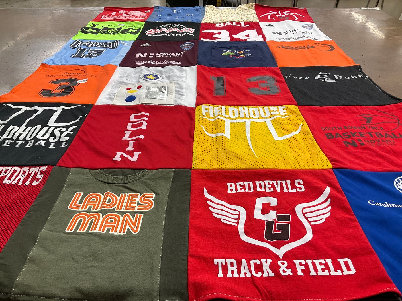 T-shirt quilt featuring red devils track and field by Emily from NC