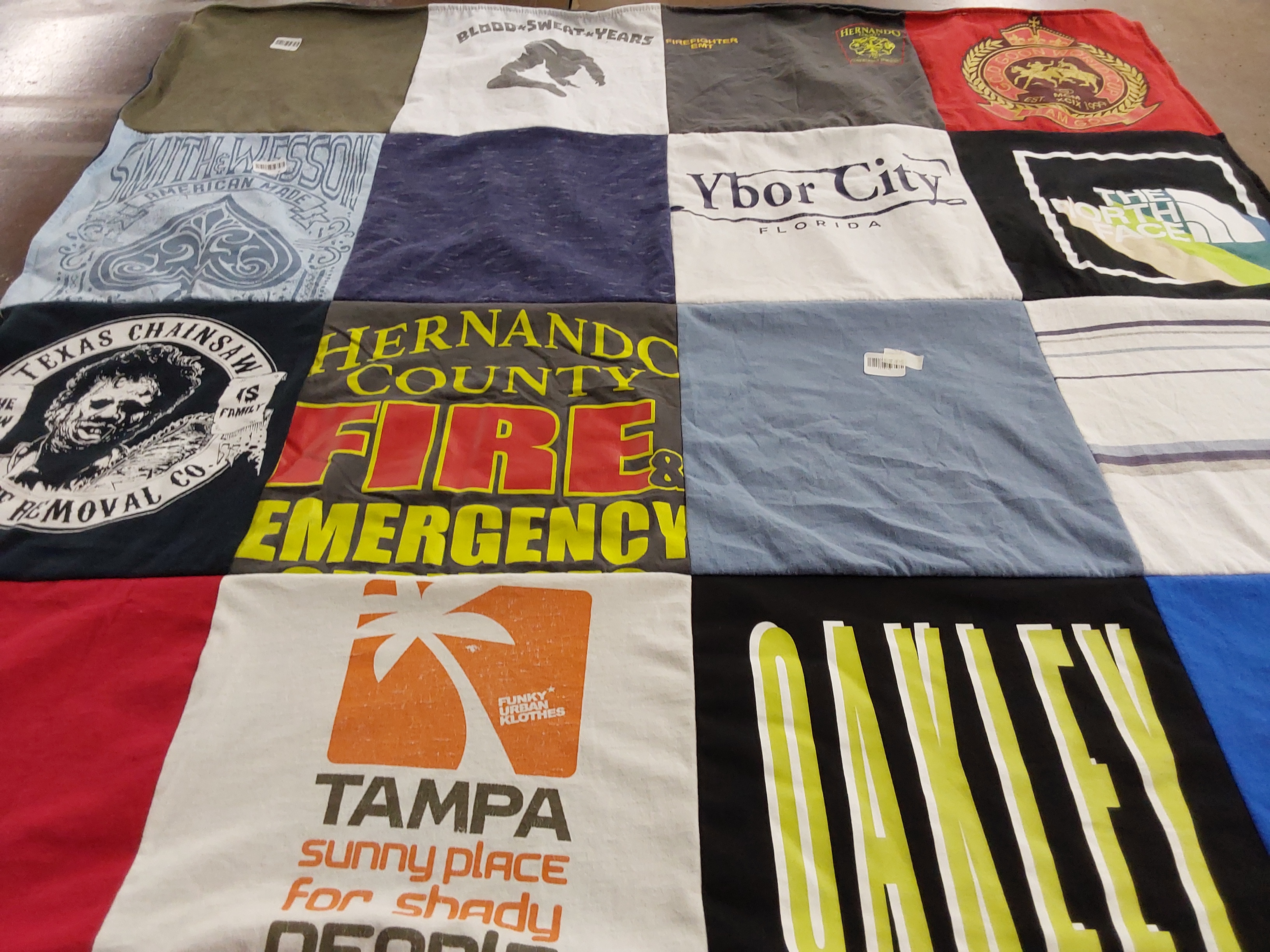 T-shirt quilt with firefighting, outdoor activities themes by Laura from AZ