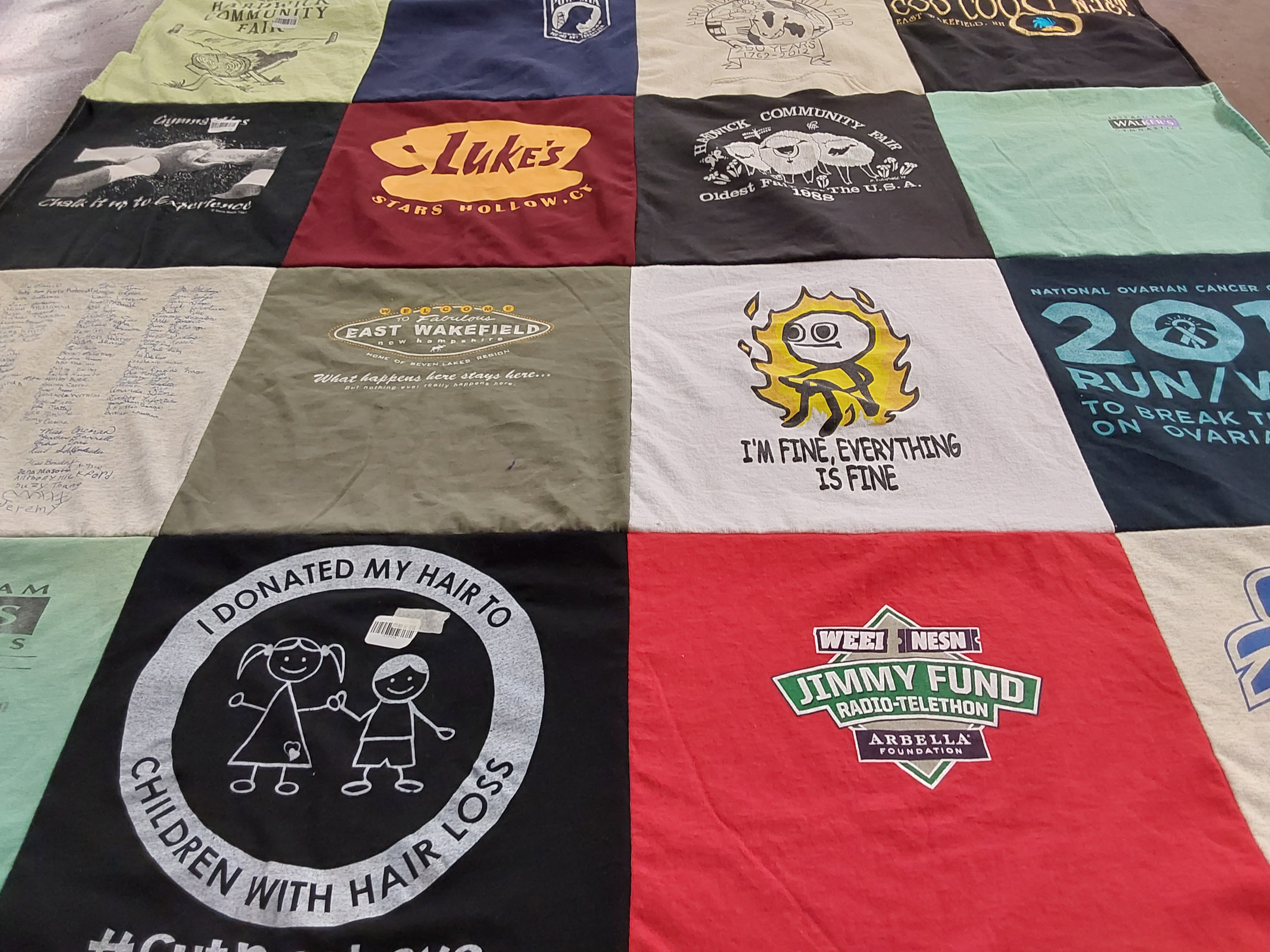 T-shirt quilt with community, charity themes by Carolyn from MA
