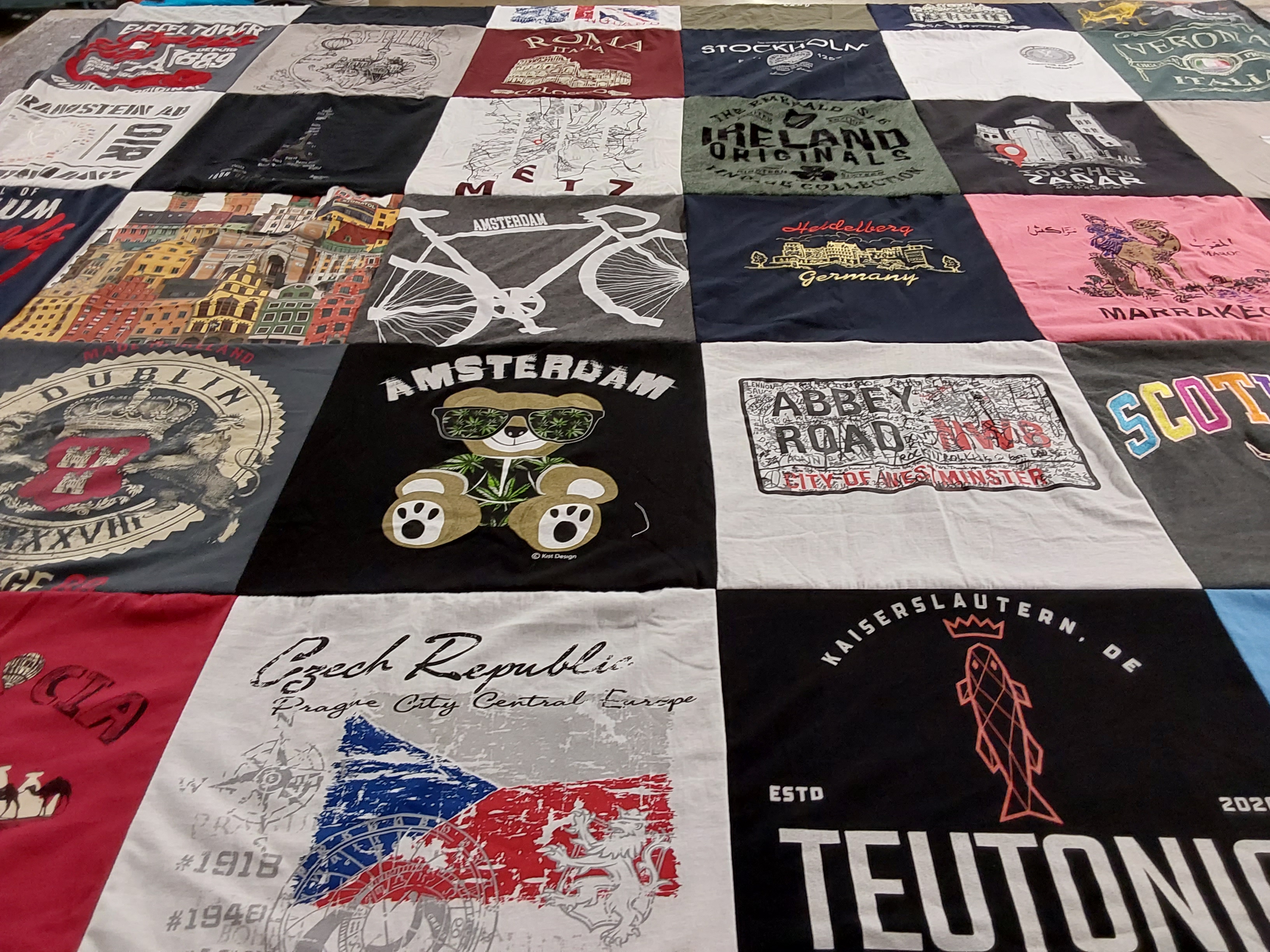 T-shirt quilt with travel, geography themes by Shene from OH