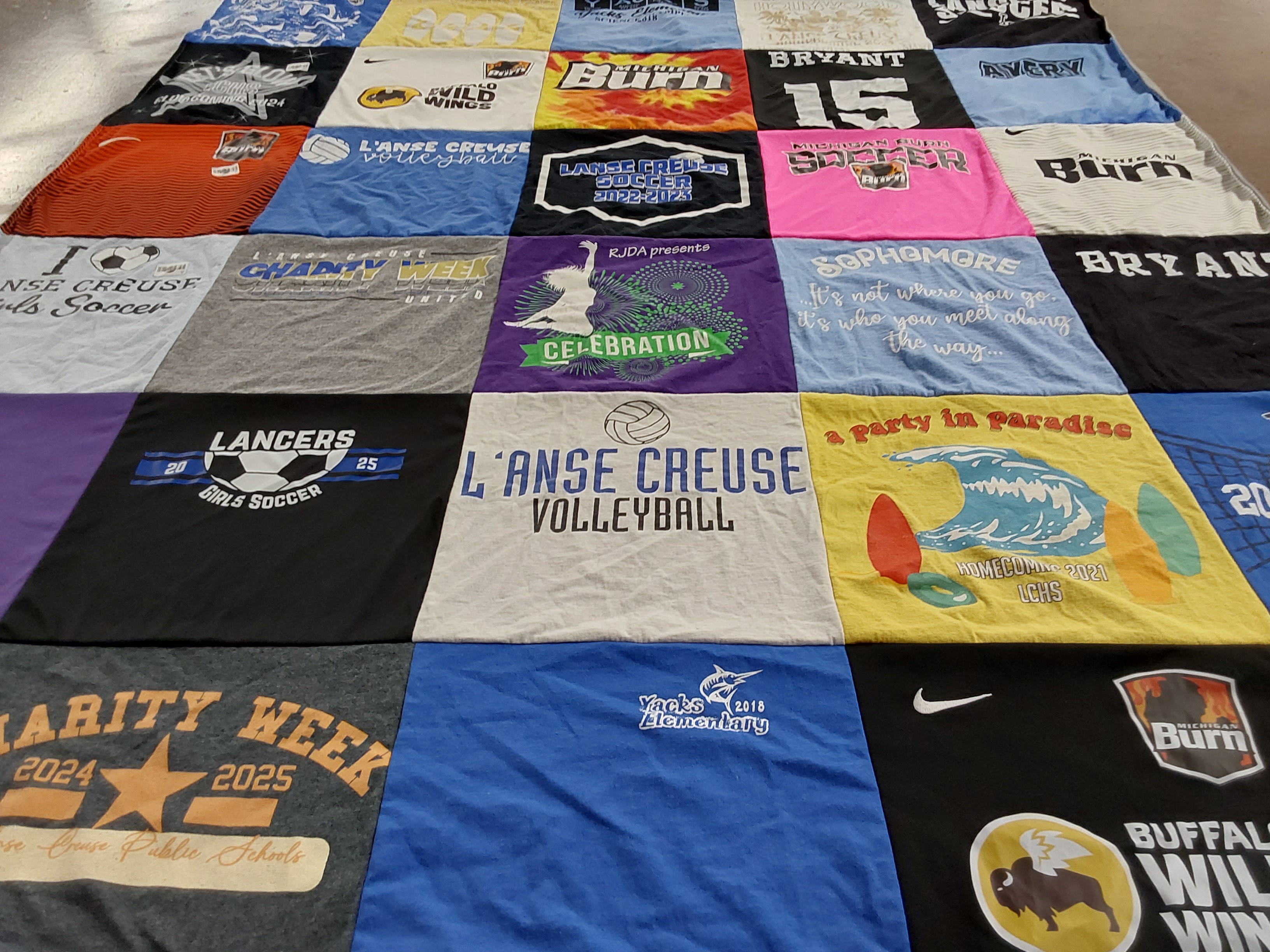 T-shirt quilt featuring l'anse creuse volleyball, michigan burn soccer by Marvin from MI
