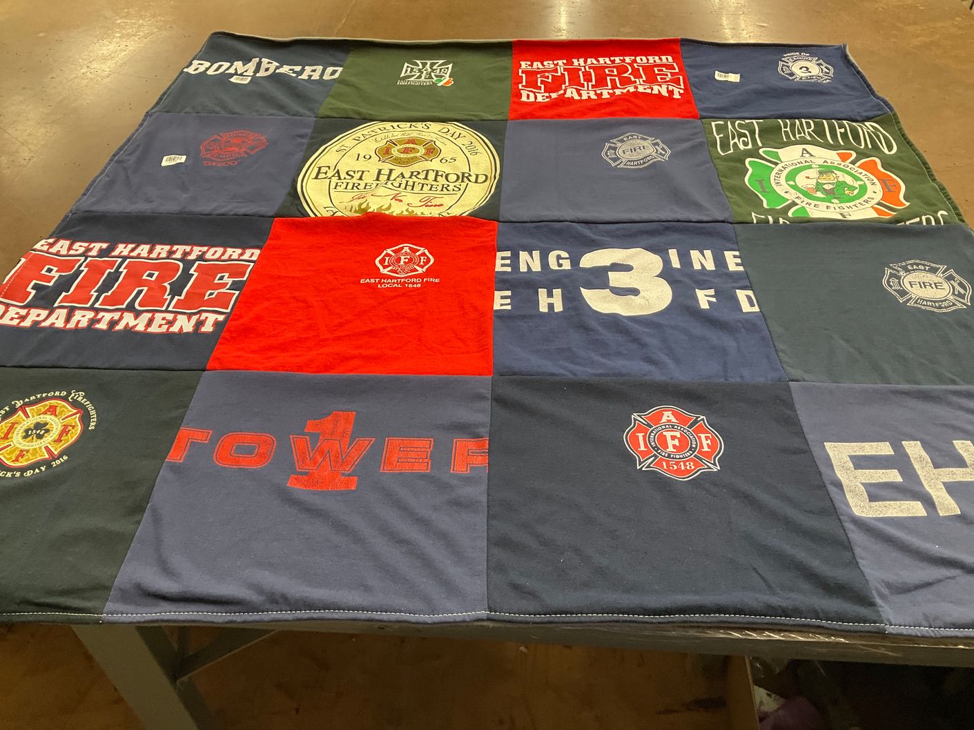 T-shirt quilt with firefighting, community service themes by Ellen from FL