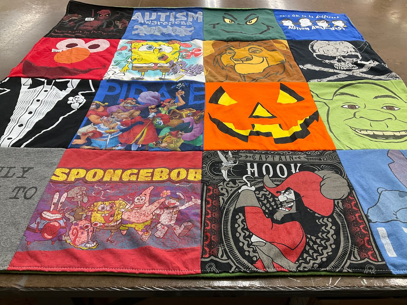 T-shirt quilt with animated shows, autism awareness themes by Edward from PA