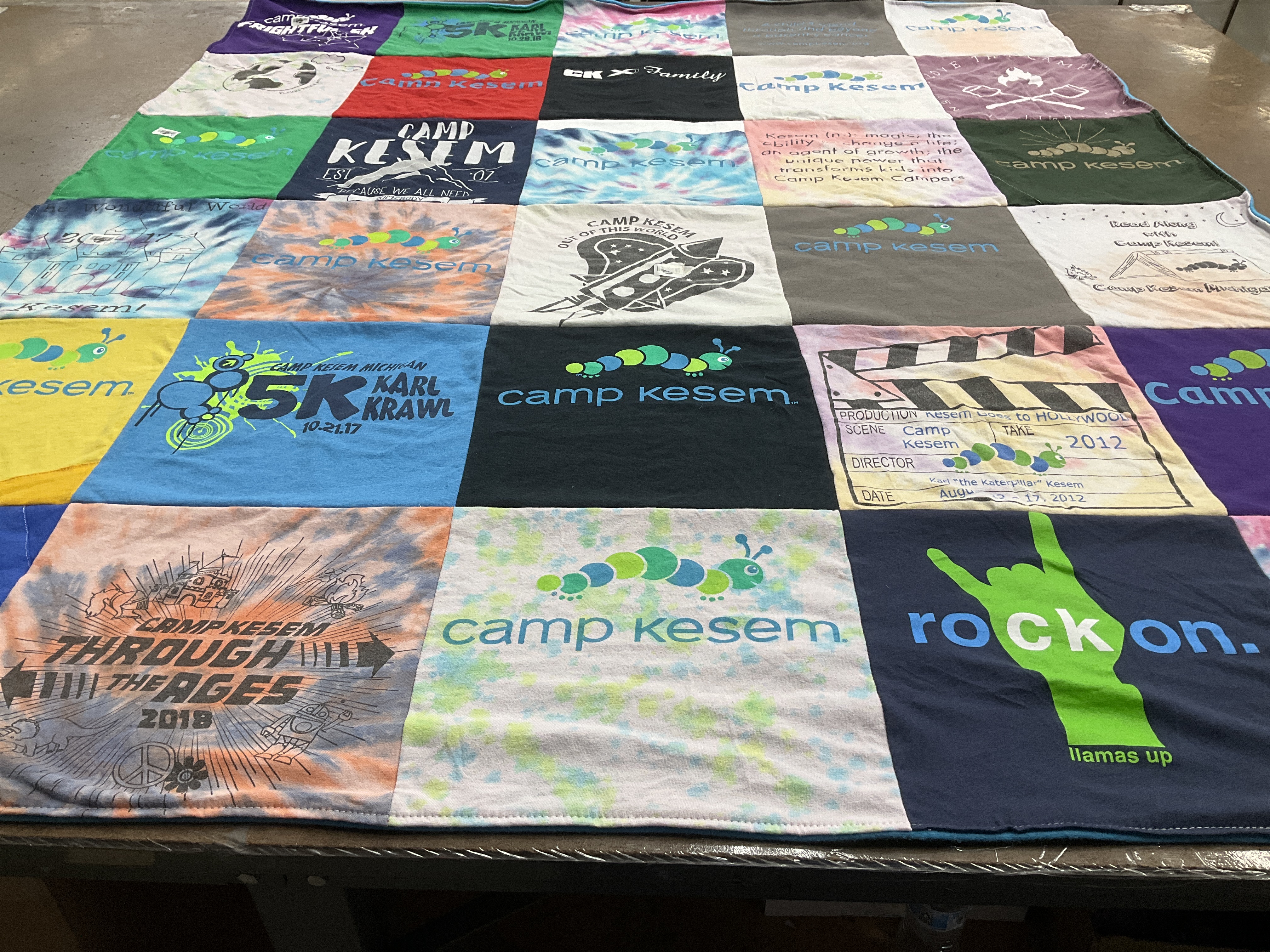 T-shirt quilt with camping, community support themes by Jenna from MI