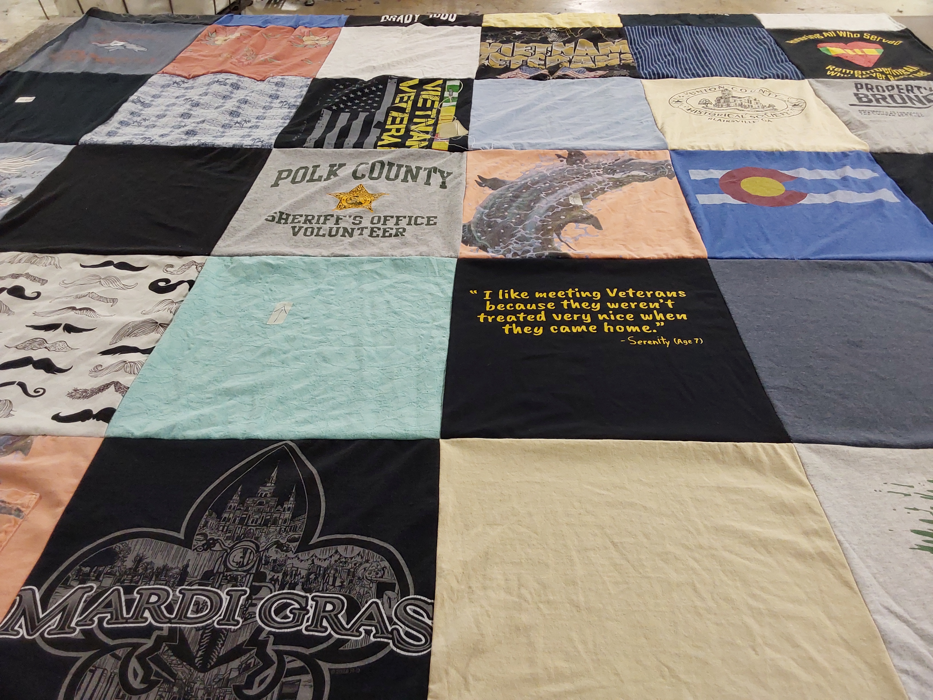 T-shirt quilt with veterans, community service themes by Cindy from FL