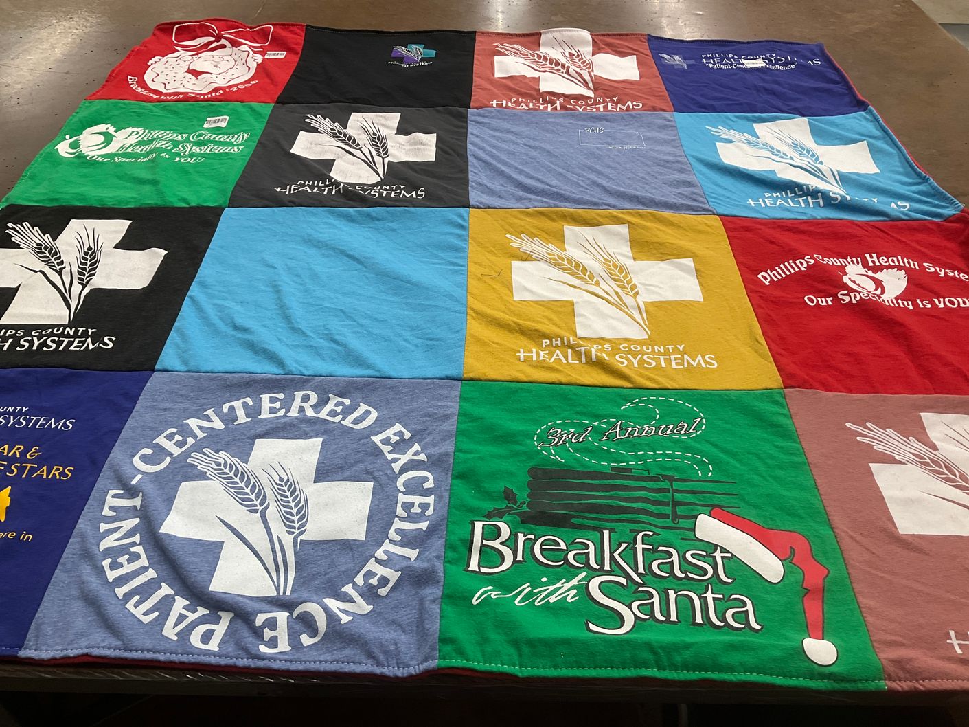 T-shirt quilt with healthcare, community events themes by Peggy from KS