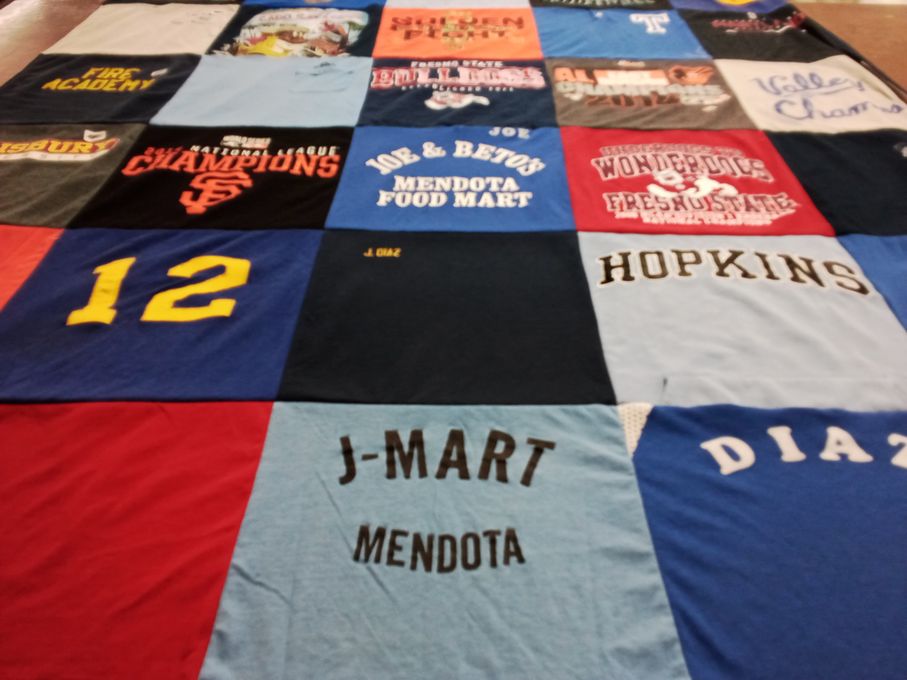 T-shirt quilt with sports, community themes by San Juanita from MD