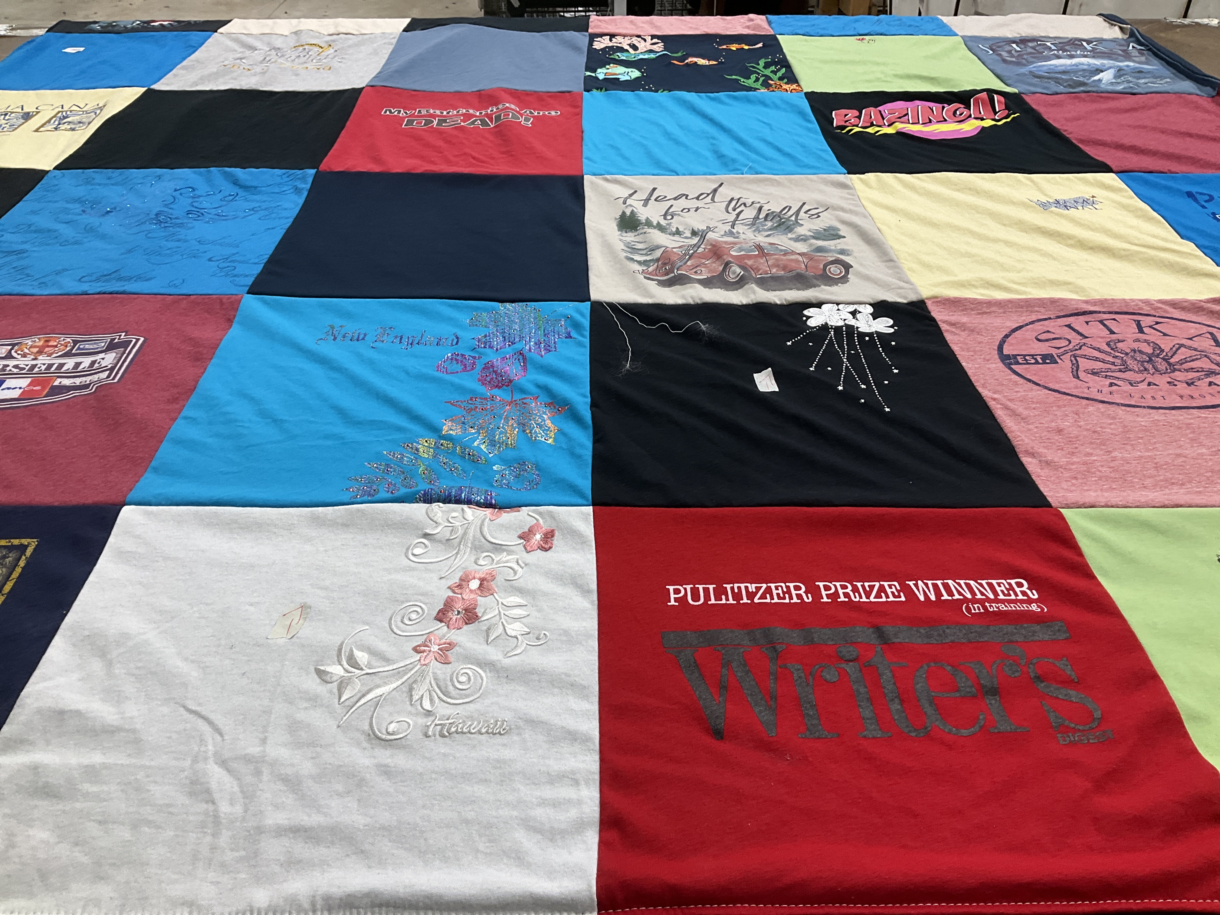 T-shirt quilt with writing, travel themes by Cindy from CO