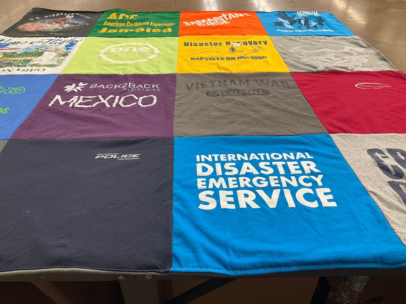 T-shirt quilt with disaster recovery, community service themes by Sue from OH