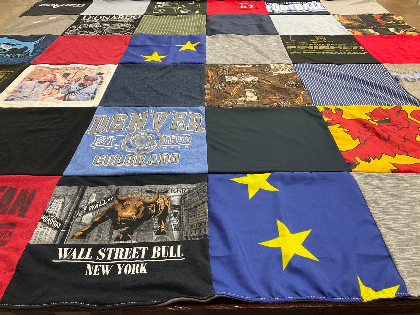 T-shirt quilt with travel, finance themes by Erinn from VT