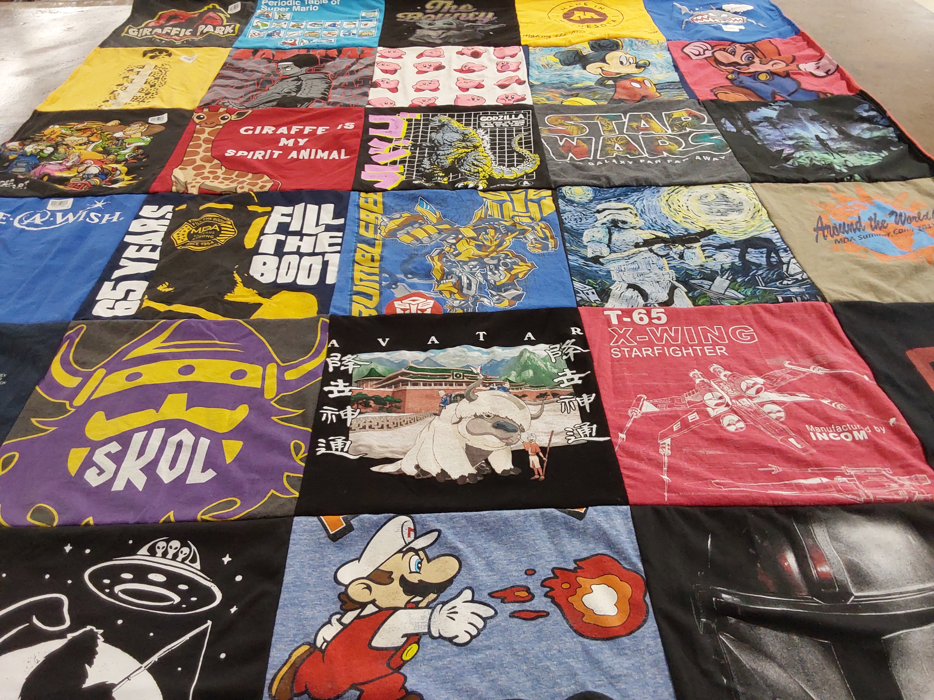 T-shirt quilt with video games, movies themes by DeLisi from MN