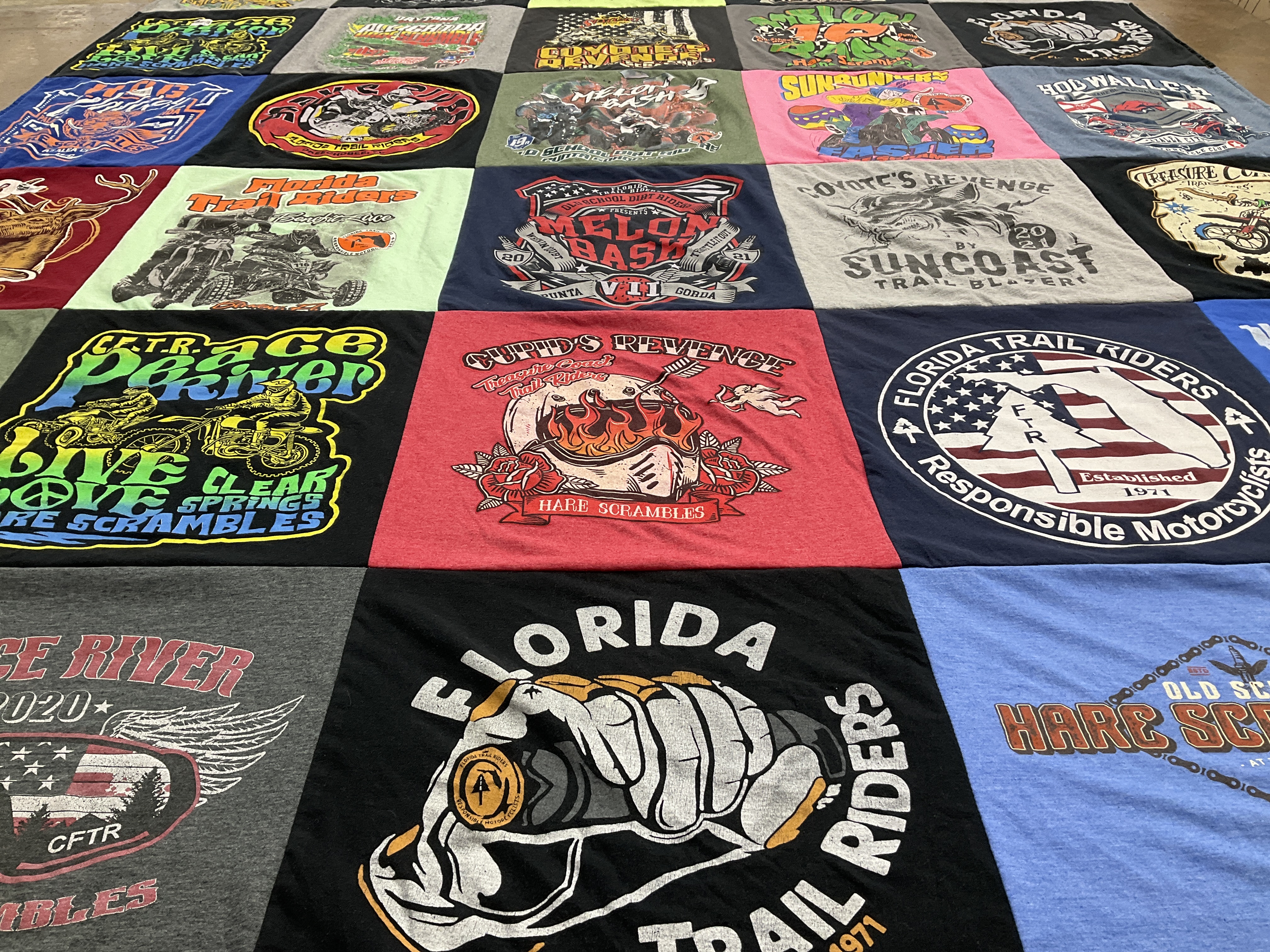 Custom Project Repat t-shirt quilt highlighting motorcycling, trail riding themes.