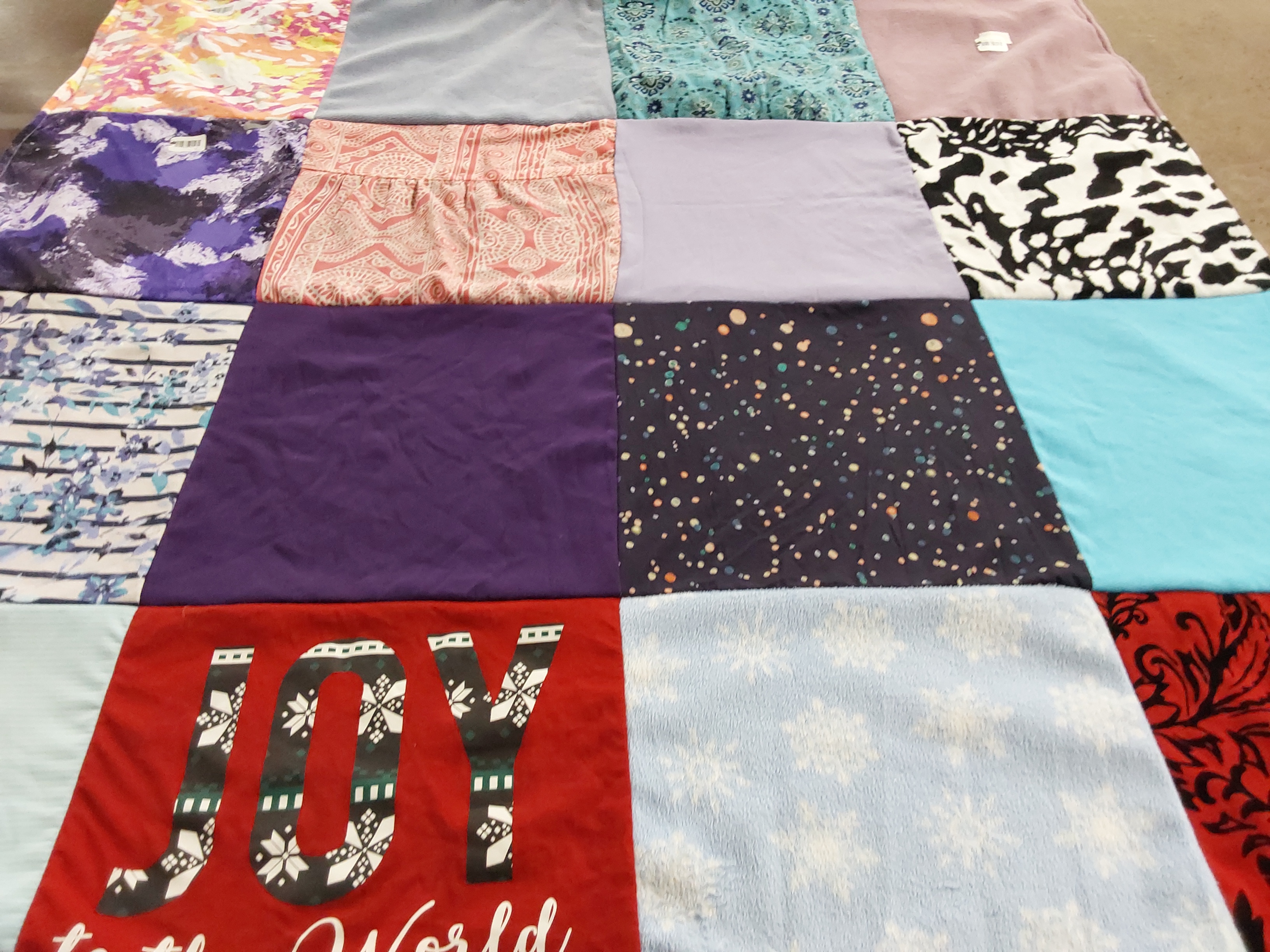 Custom Project Repat t-shirt quilt highlighting sewing, quilting themes.