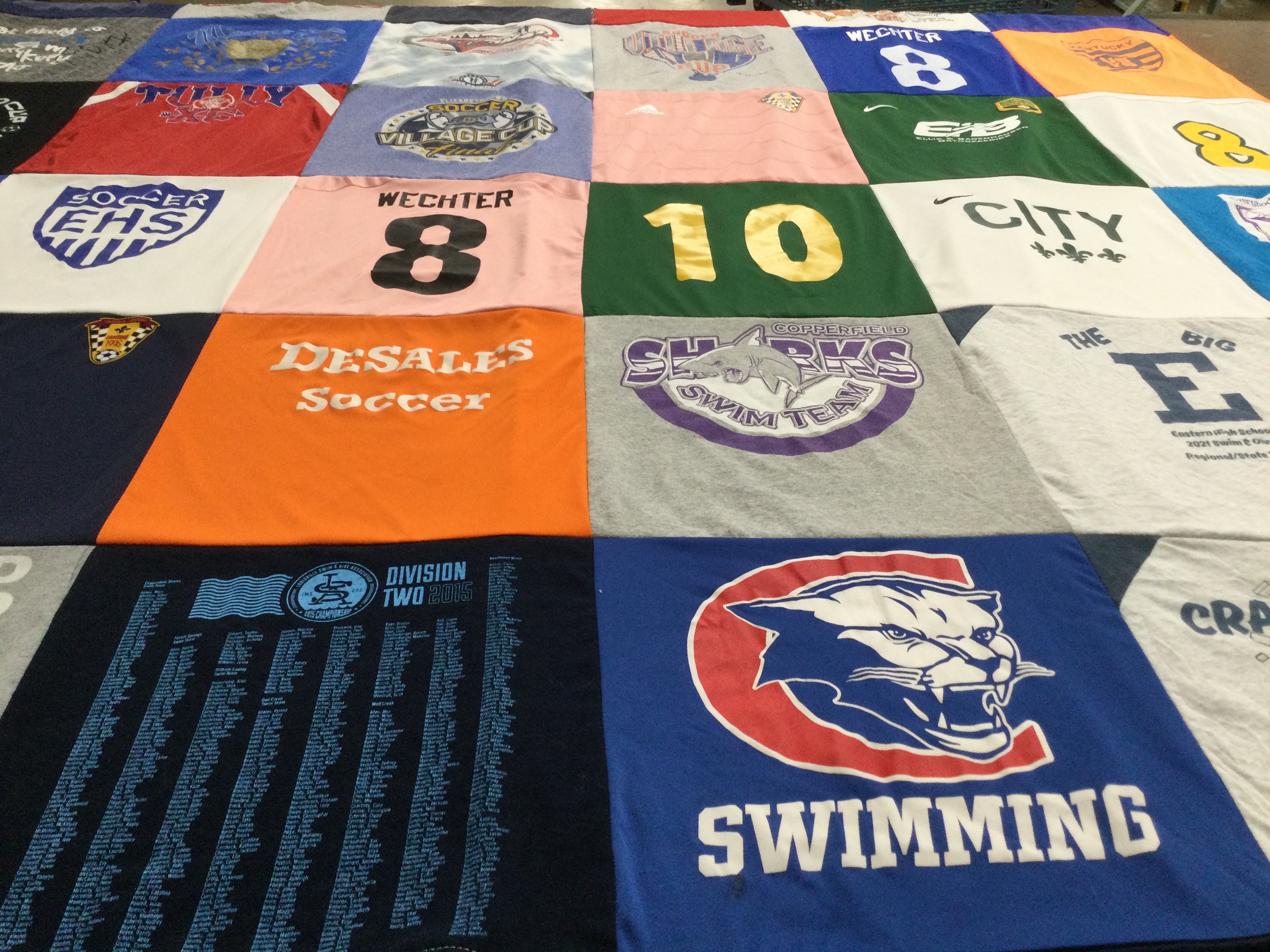 T-shirt quilt featuring sharks swim team by Bree from KY