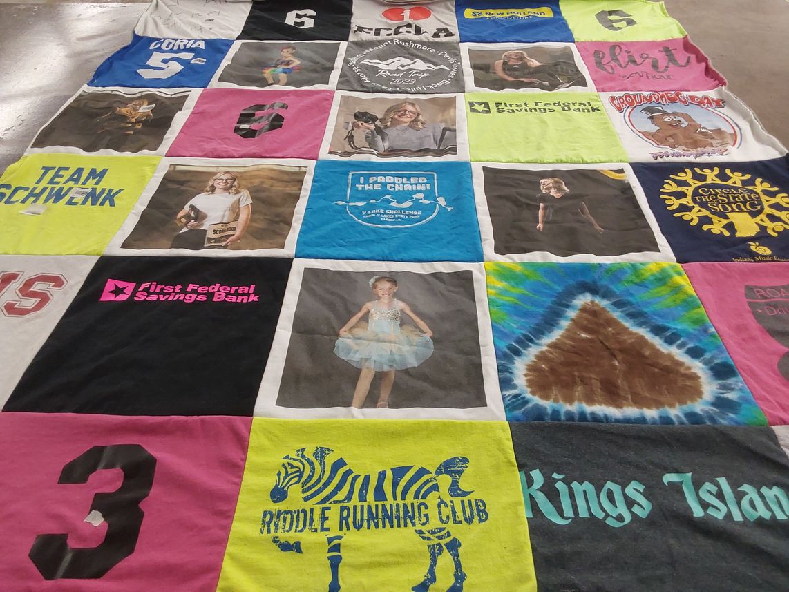 T-shirt quilt with running, banking themes by Ashley from IN