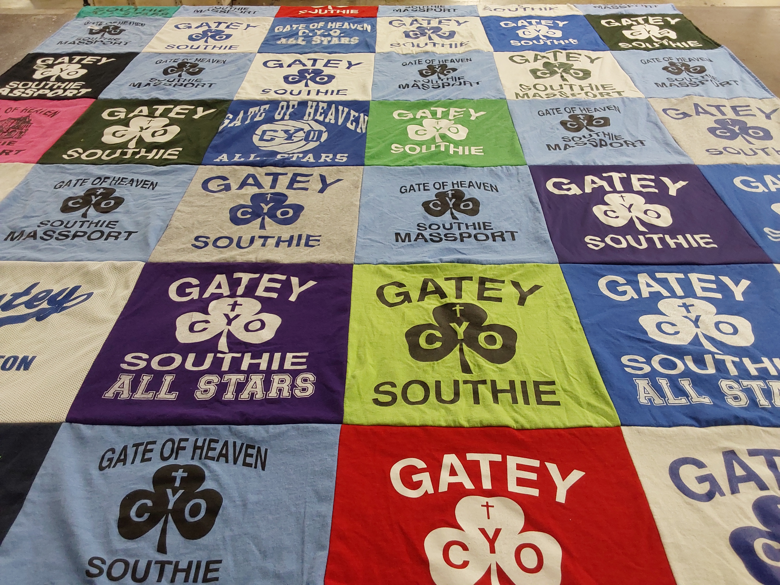 T-shirt quilt with sports, community themes by Marie from MA