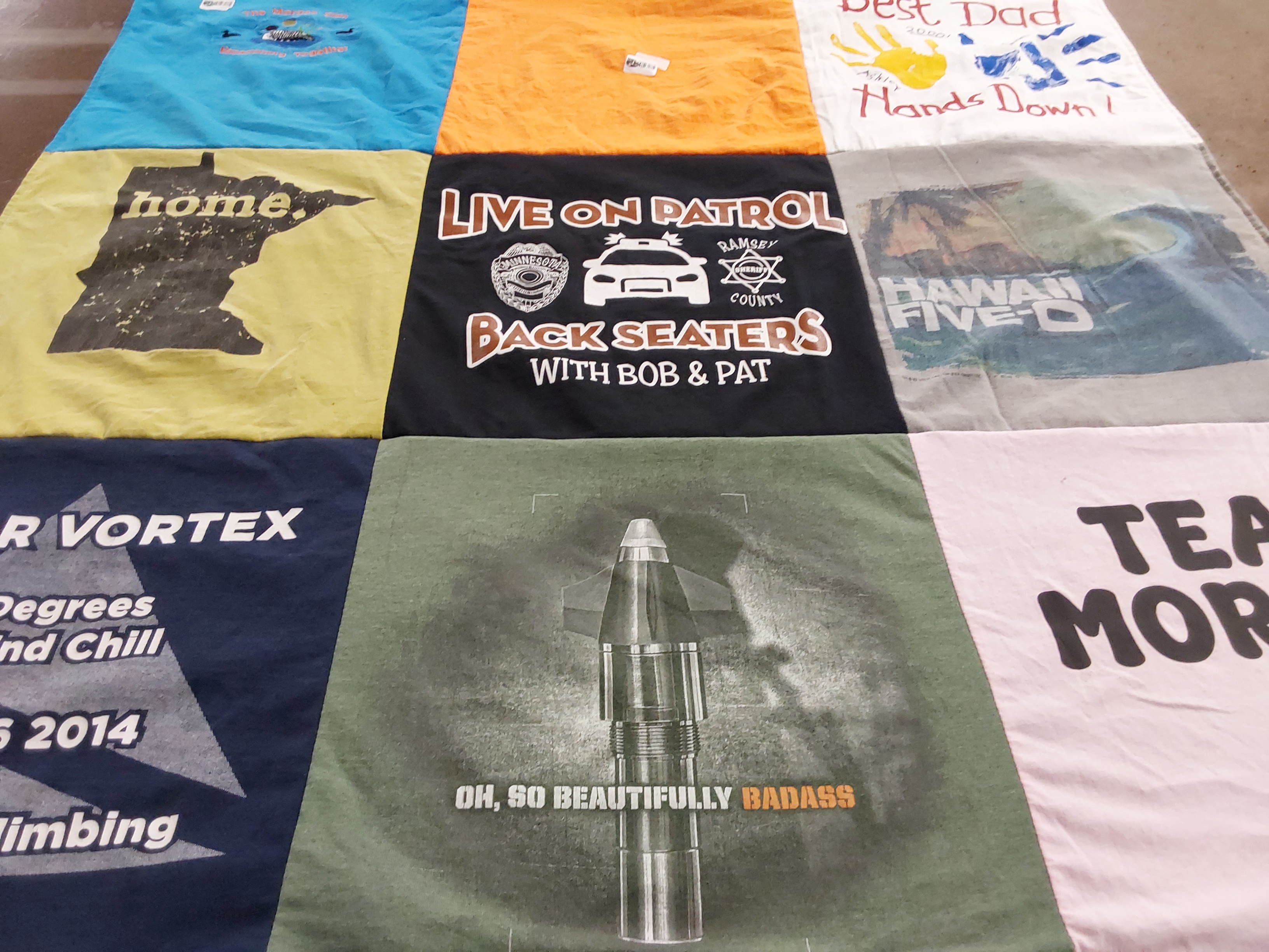 T-shirt quilt with climbing, law enforcement themes by Joanne from MN