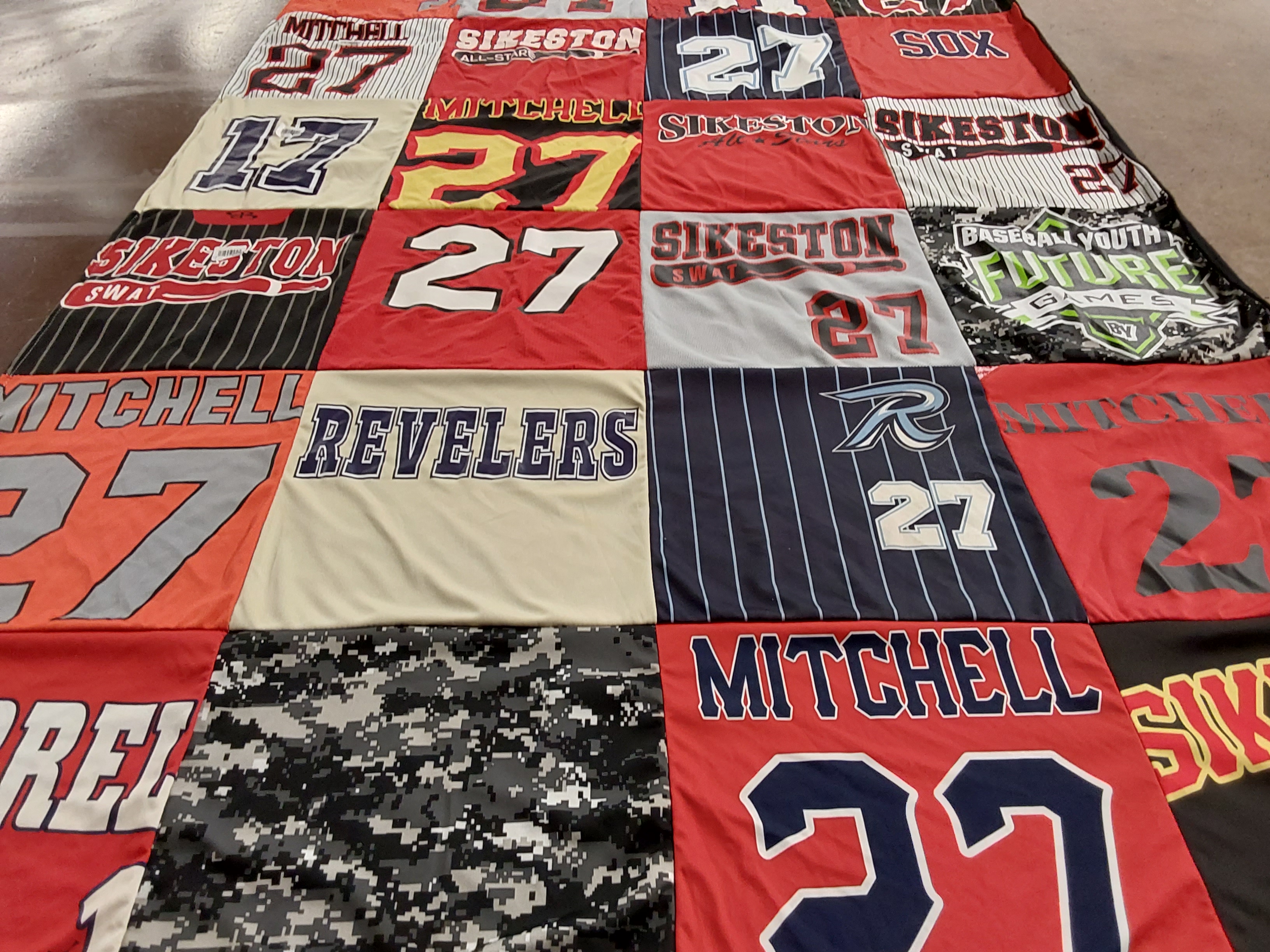 Custom Project Repat t-shirt quilt highlighting baseball, sports themes.