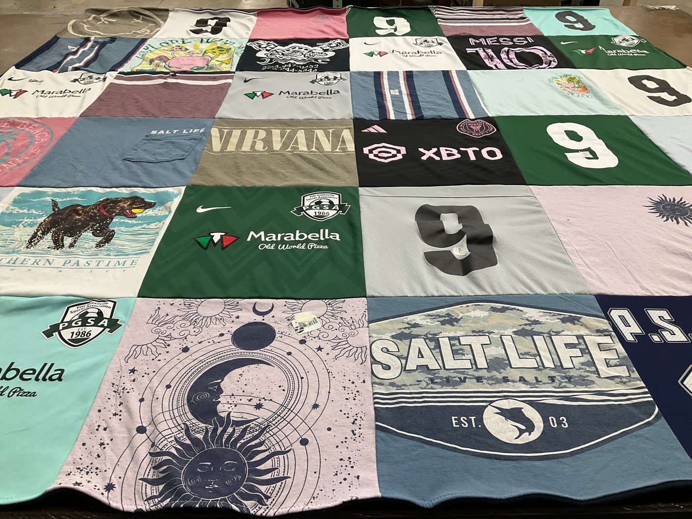 T-shirt quilt with sports, music themes by Cynthia from NC