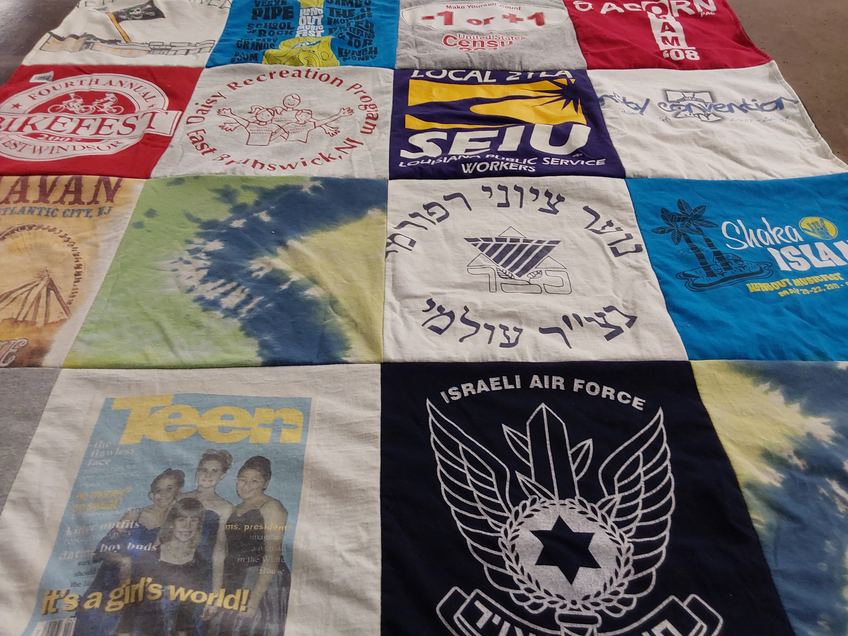 T-shirt quilt with cycling, community programs themes by Ellen from NJ