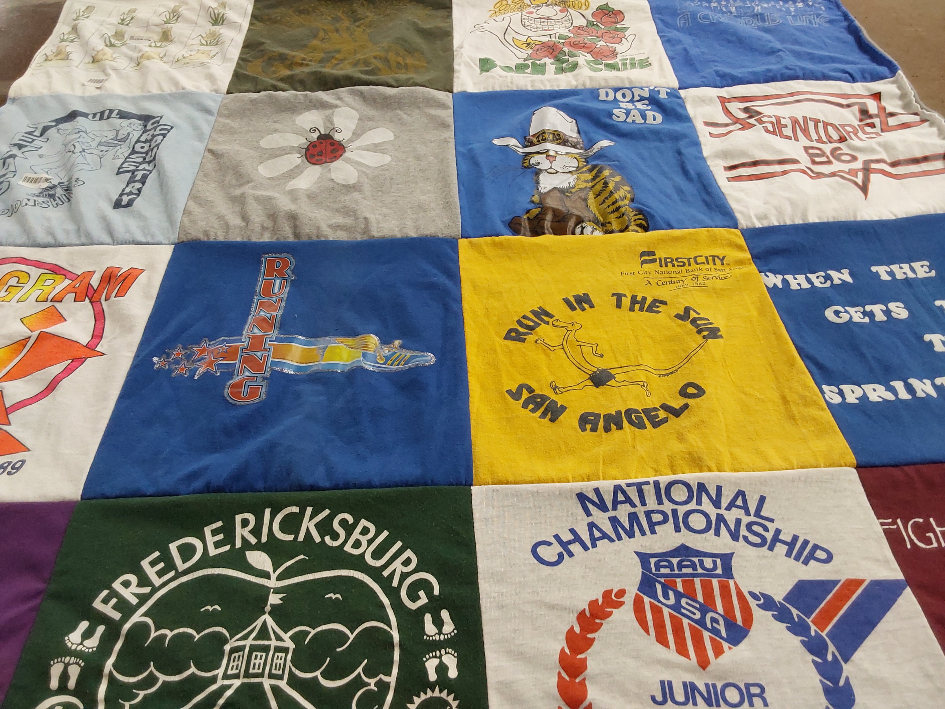T-shirt quilt with running, community events themes by Susan from TX