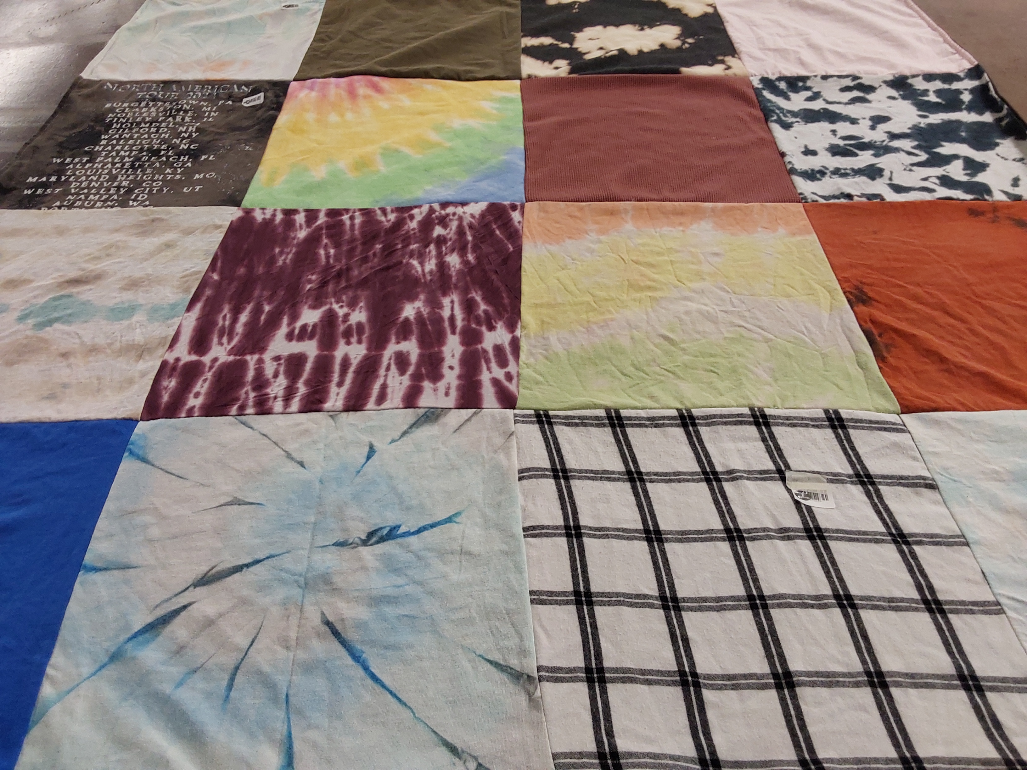 Custom Project Repat t-shirt quilt highlighting traveling, tourism themes.