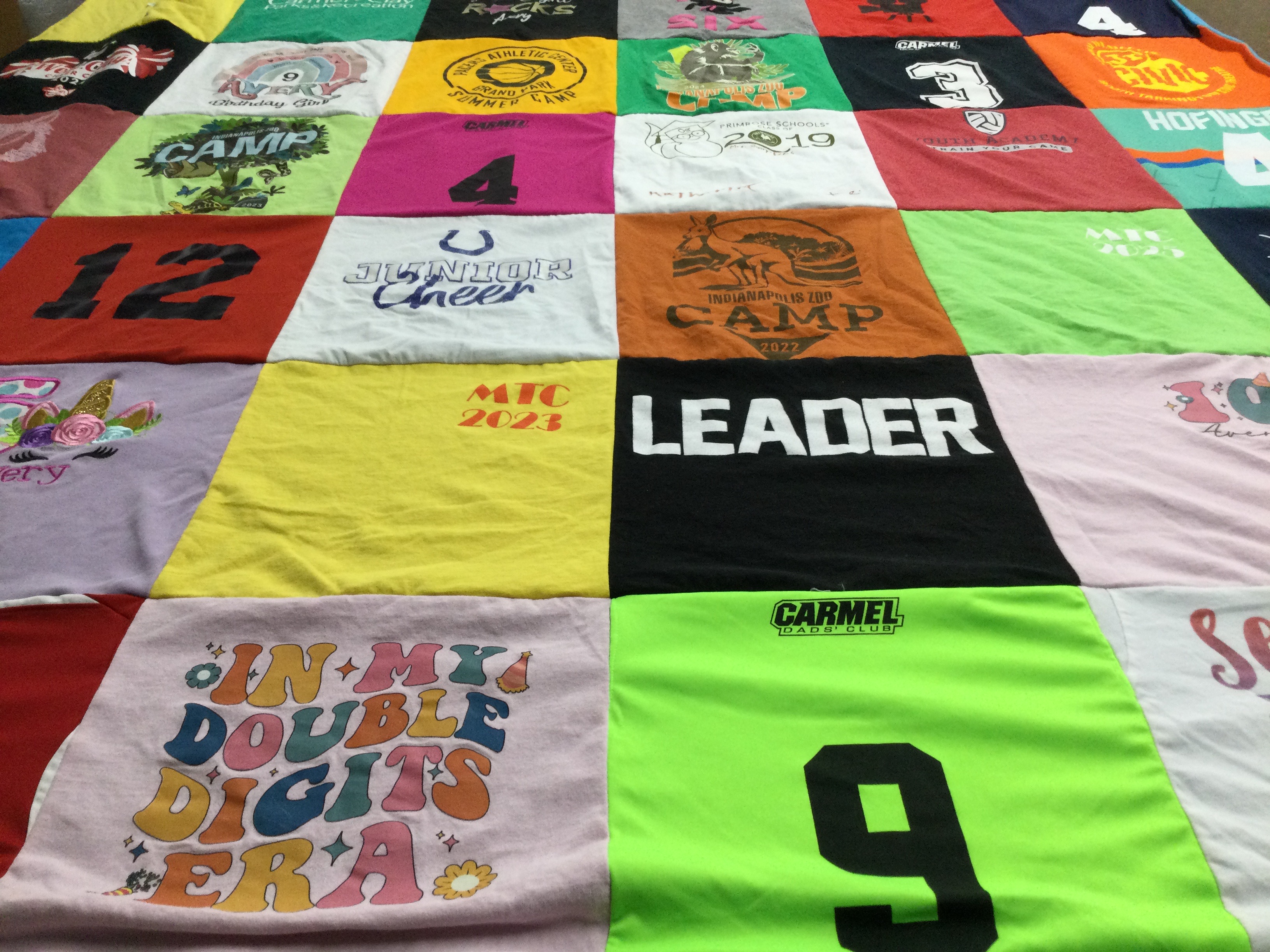 T-shirt quilt with cheerleading, summer camps themes by Stacy from IN