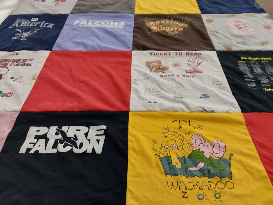 T-shirt quilt with reading, travel themes by Jennifer from KS
