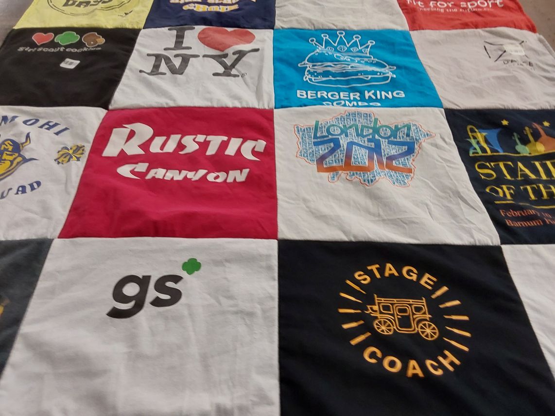 T-shirt quilt with travel, food themes by Elizabeth from CA