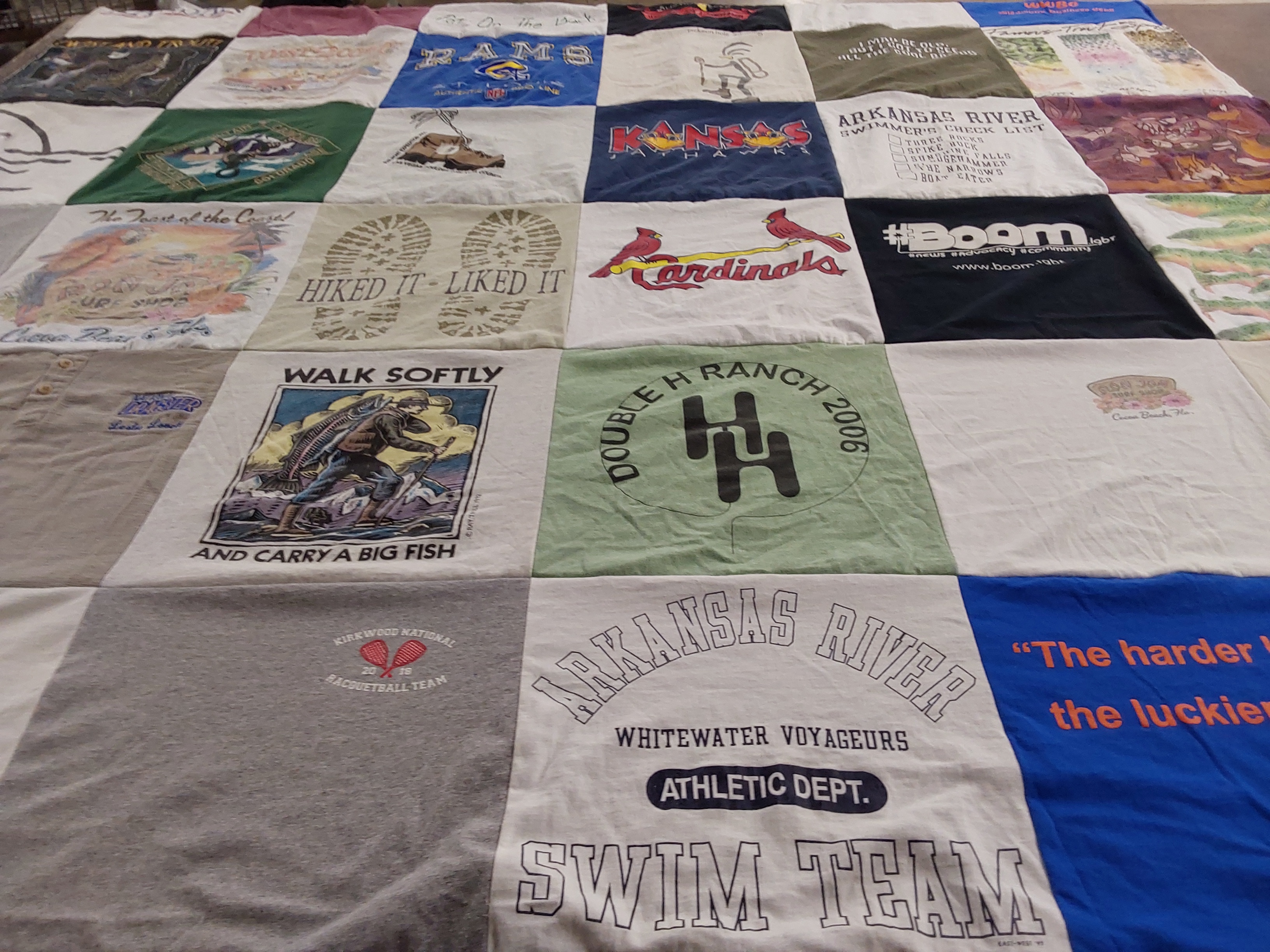 Custom Project Repat t-shirt quilt highlighting fishing, hiking themes.