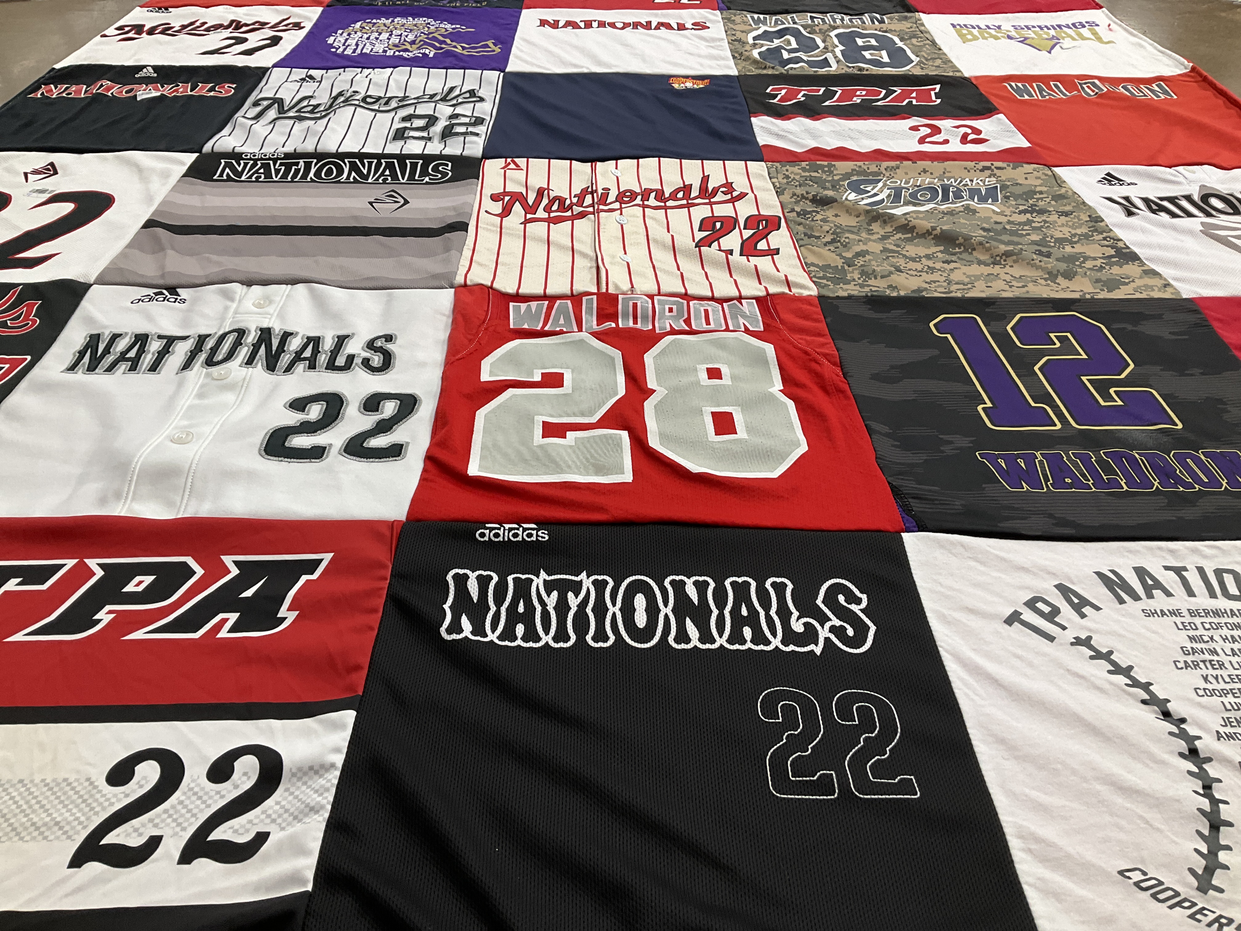 Custom Project Repat t-shirt quilt highlighting baseball, sports themes.