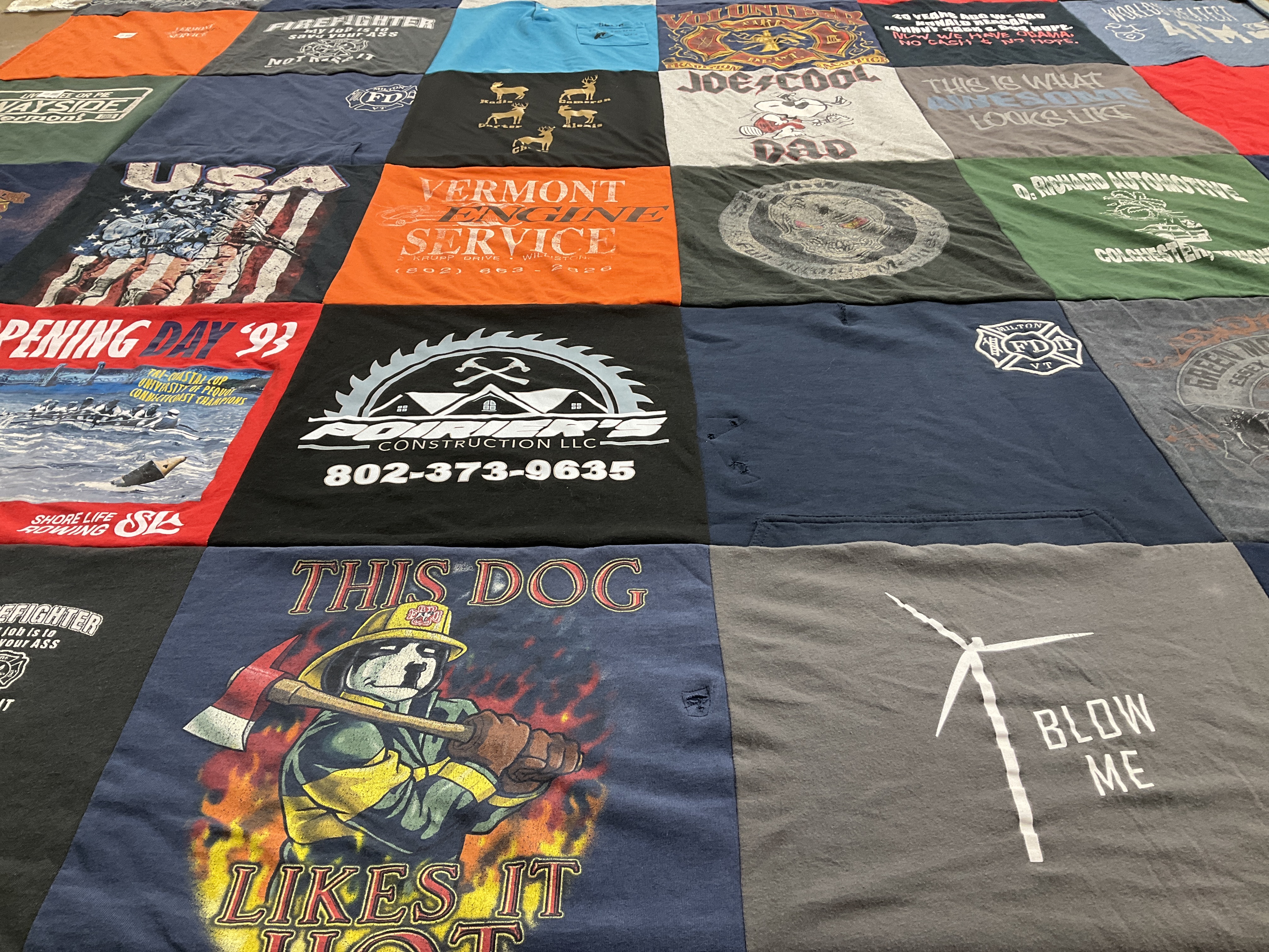 Custom Project Repat t-shirt quilt highlighting firefighting, construction themes.