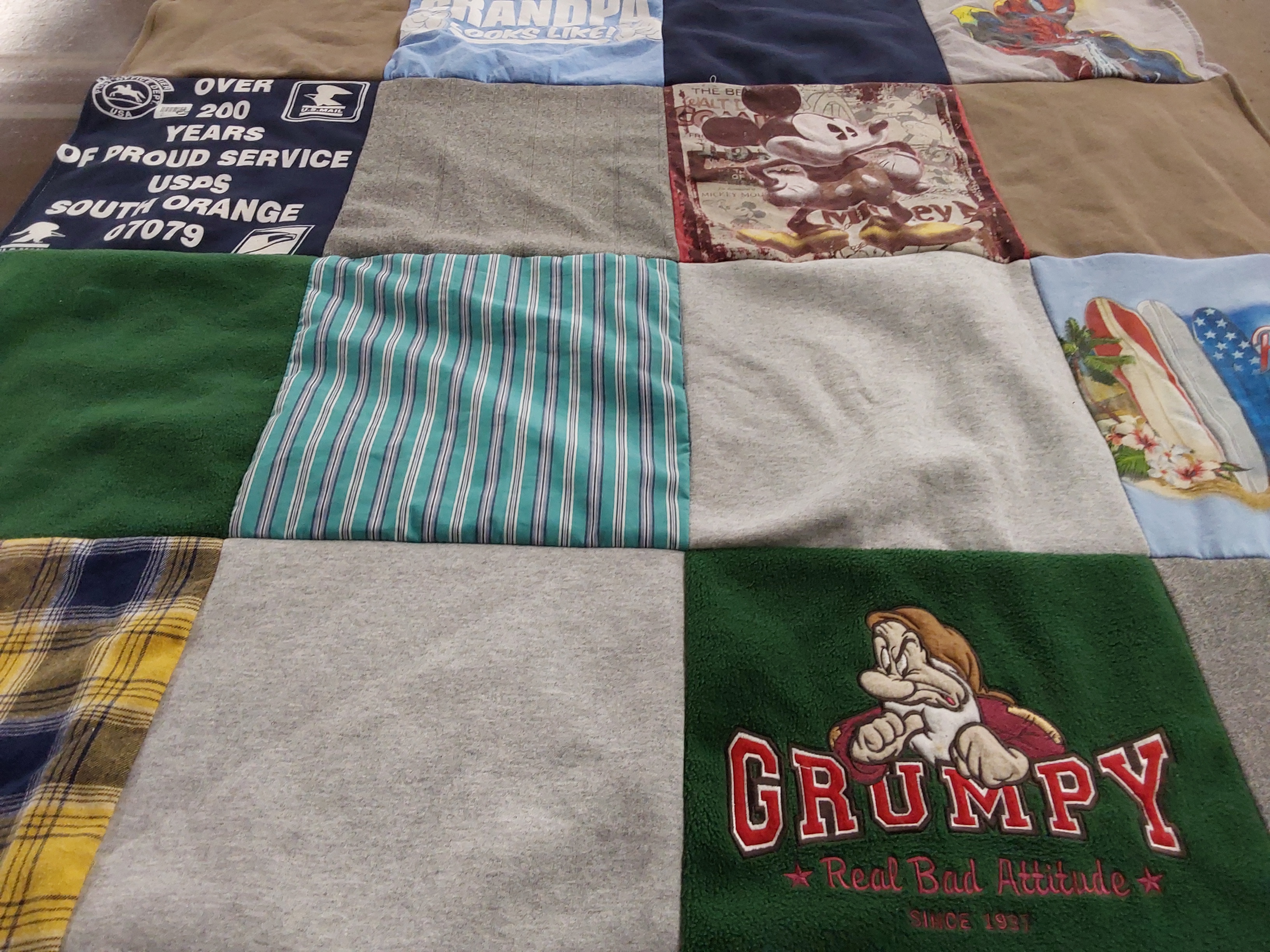 T-shirt quilt with disney, postal service themes by Emily from NJ