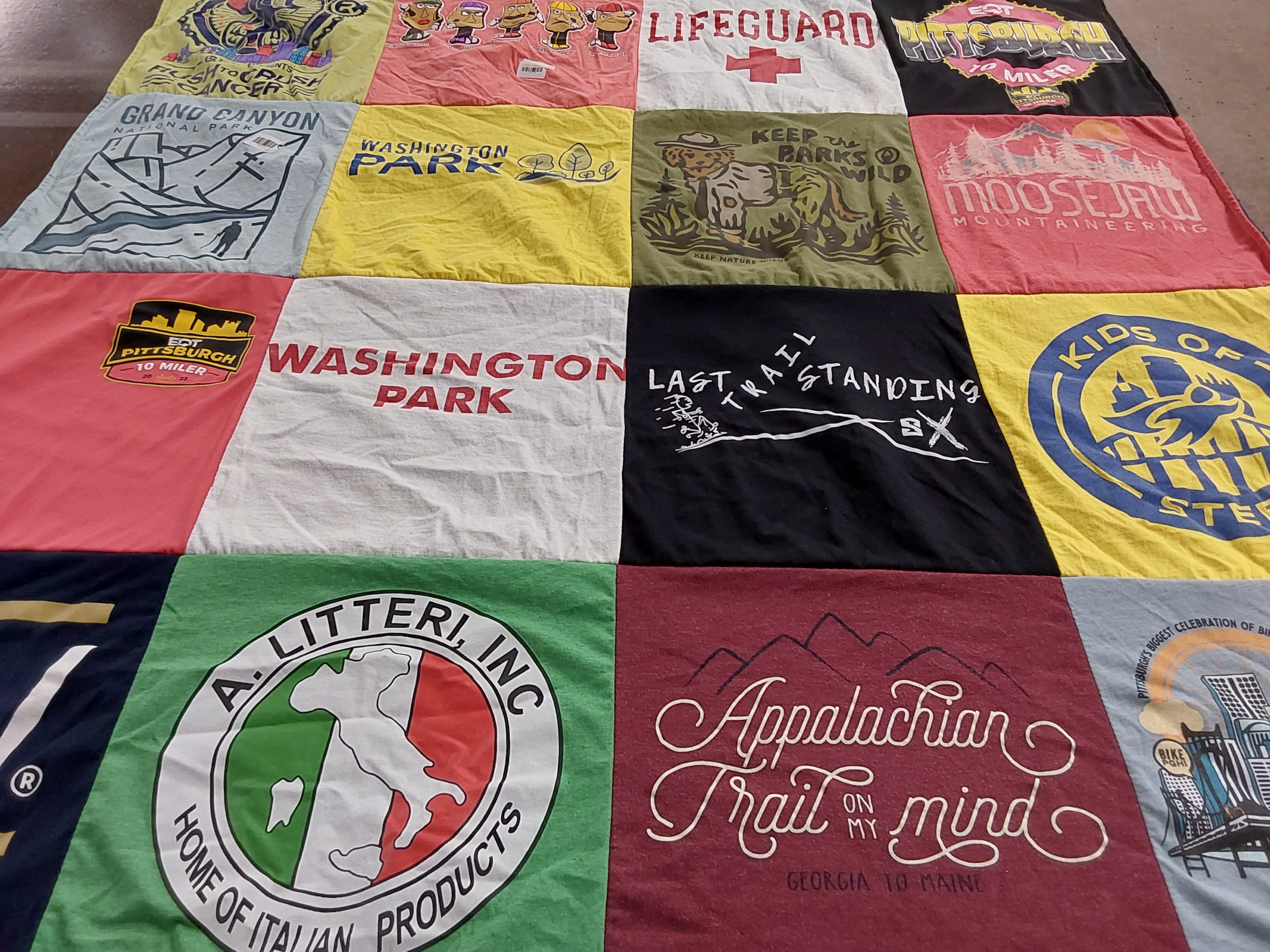 Custom Project Repat t-shirt quilt highlighting hiking, outdoor activities themes.