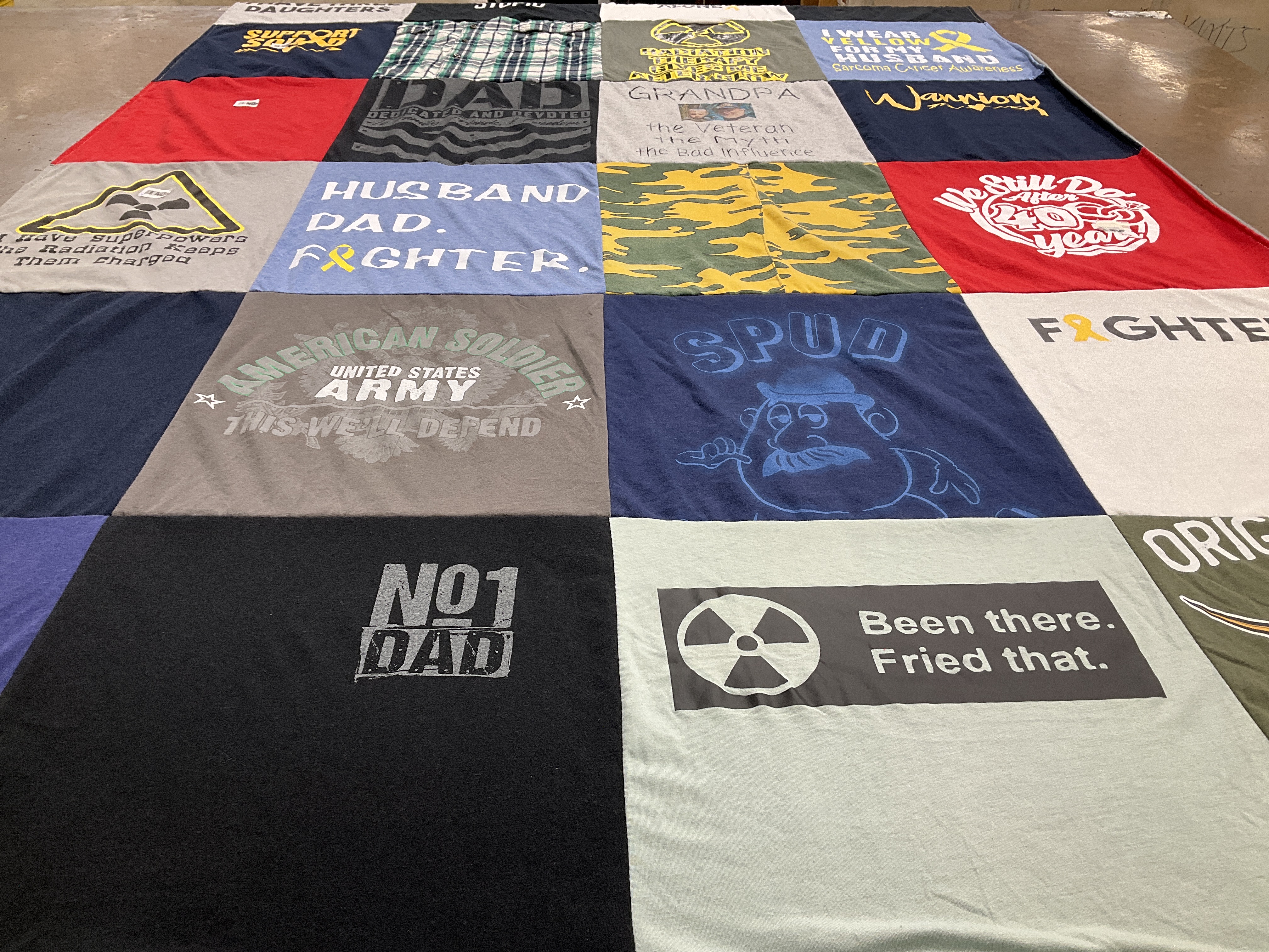 Custom Project Repat t-shirt quilt highlighting veterans, family themes.