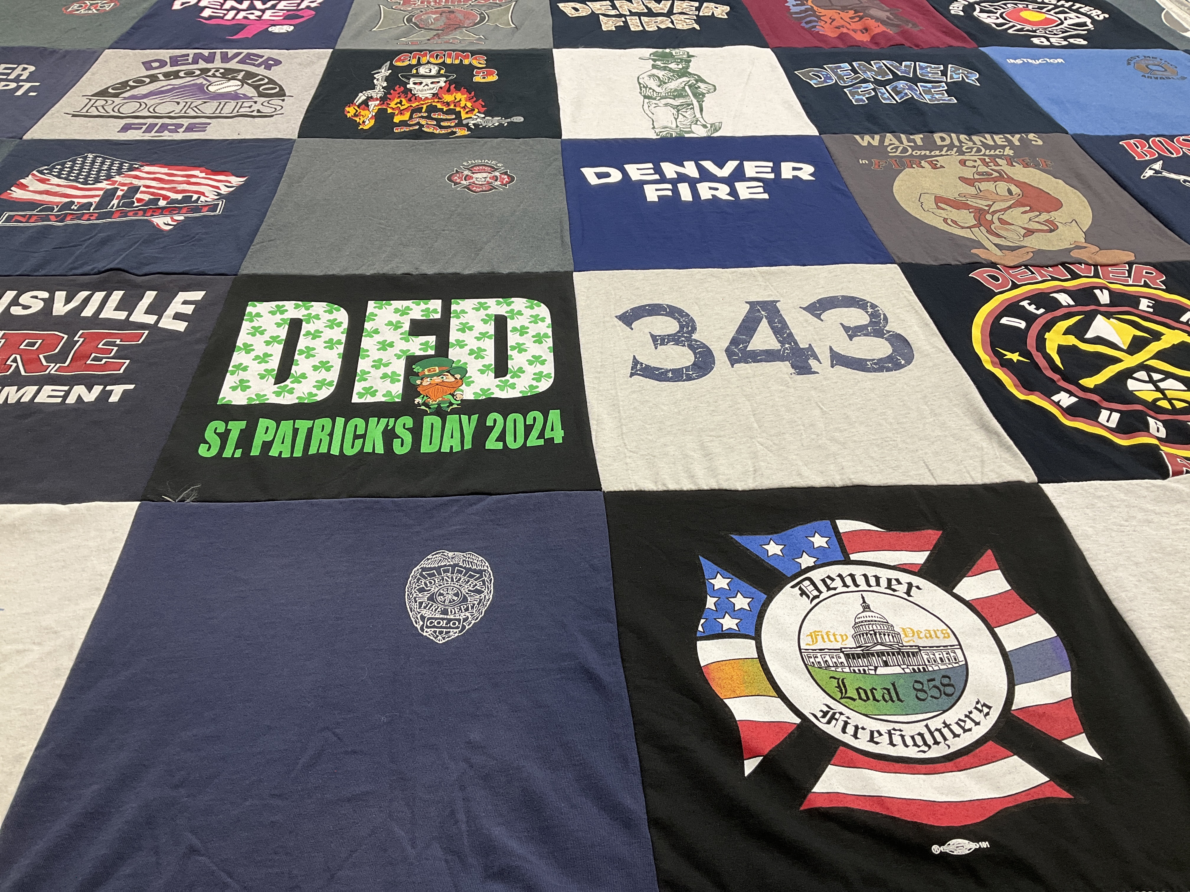 T-shirt quilt with firefighting, community themes by Kristyn from CO