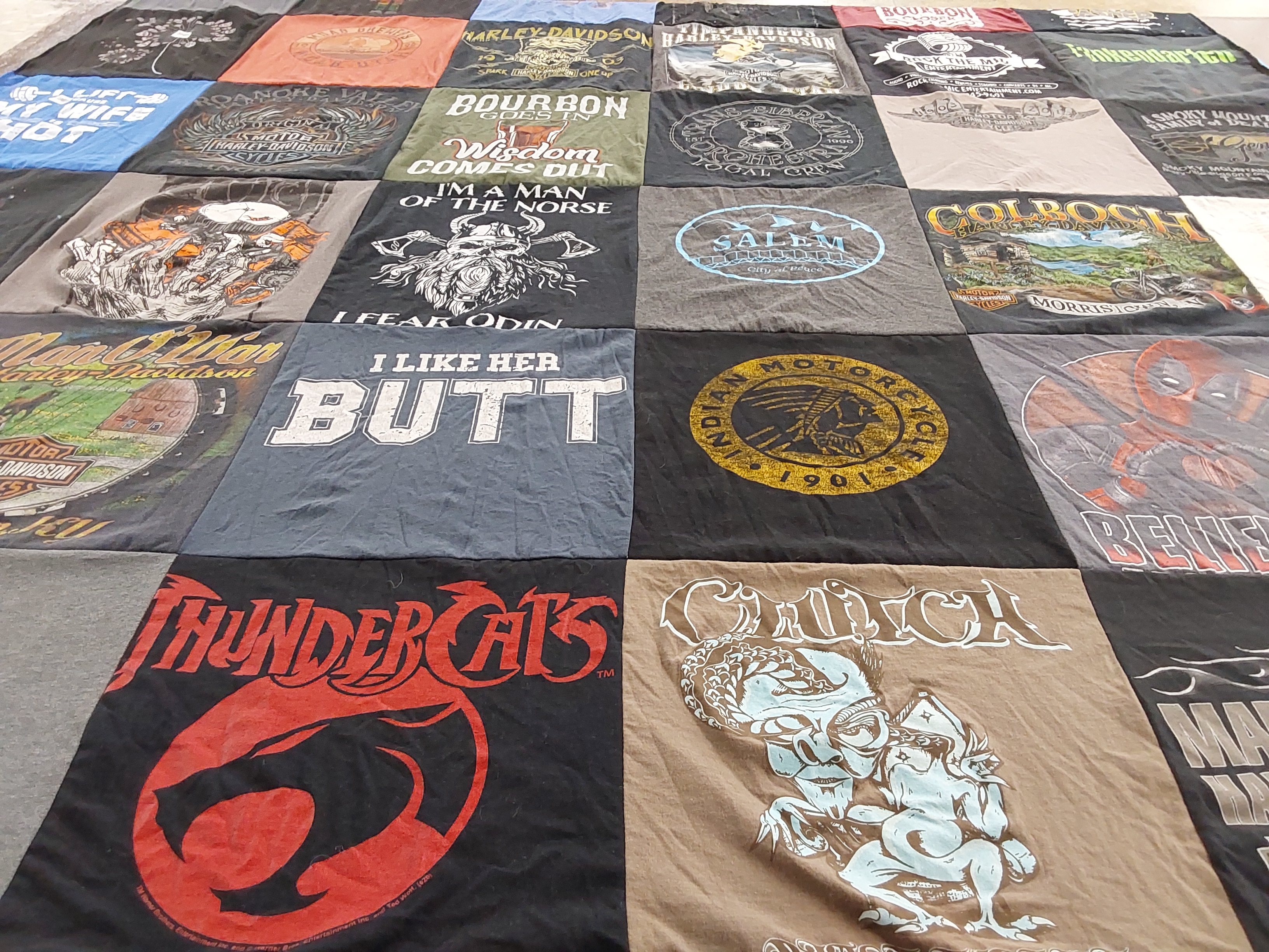 Custom Project Repat t-shirt quilt highlighting motorcycles, humor themes.