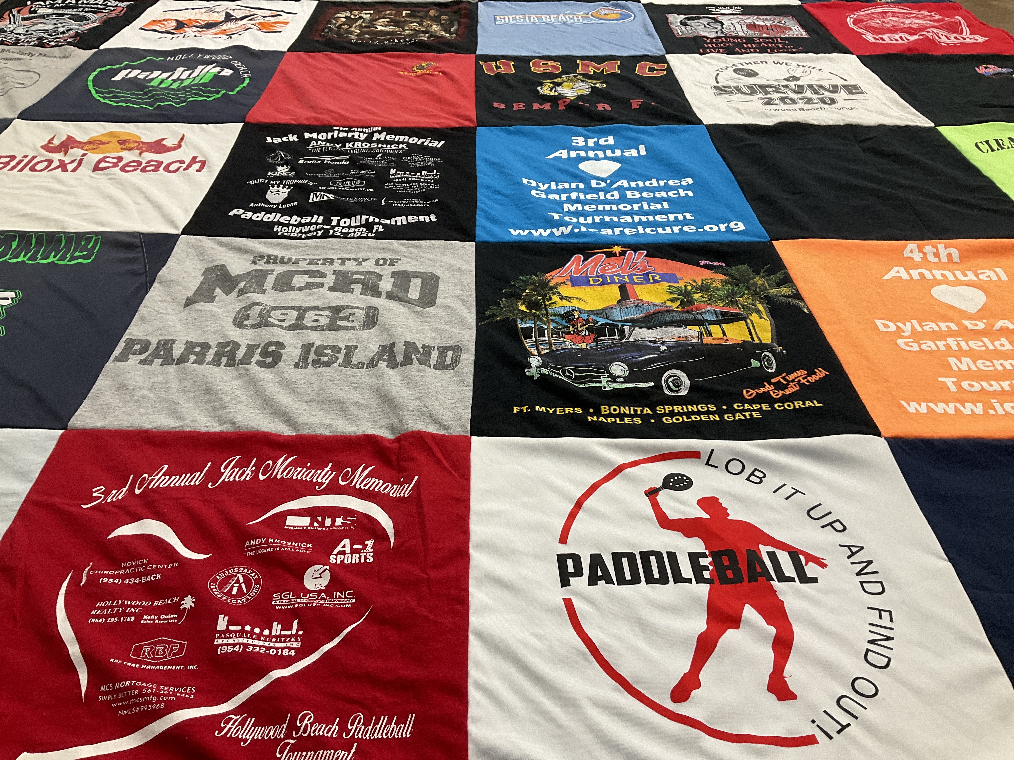 Custom Project Repat t-shirt quilt highlighting paddleball, beach themes.
