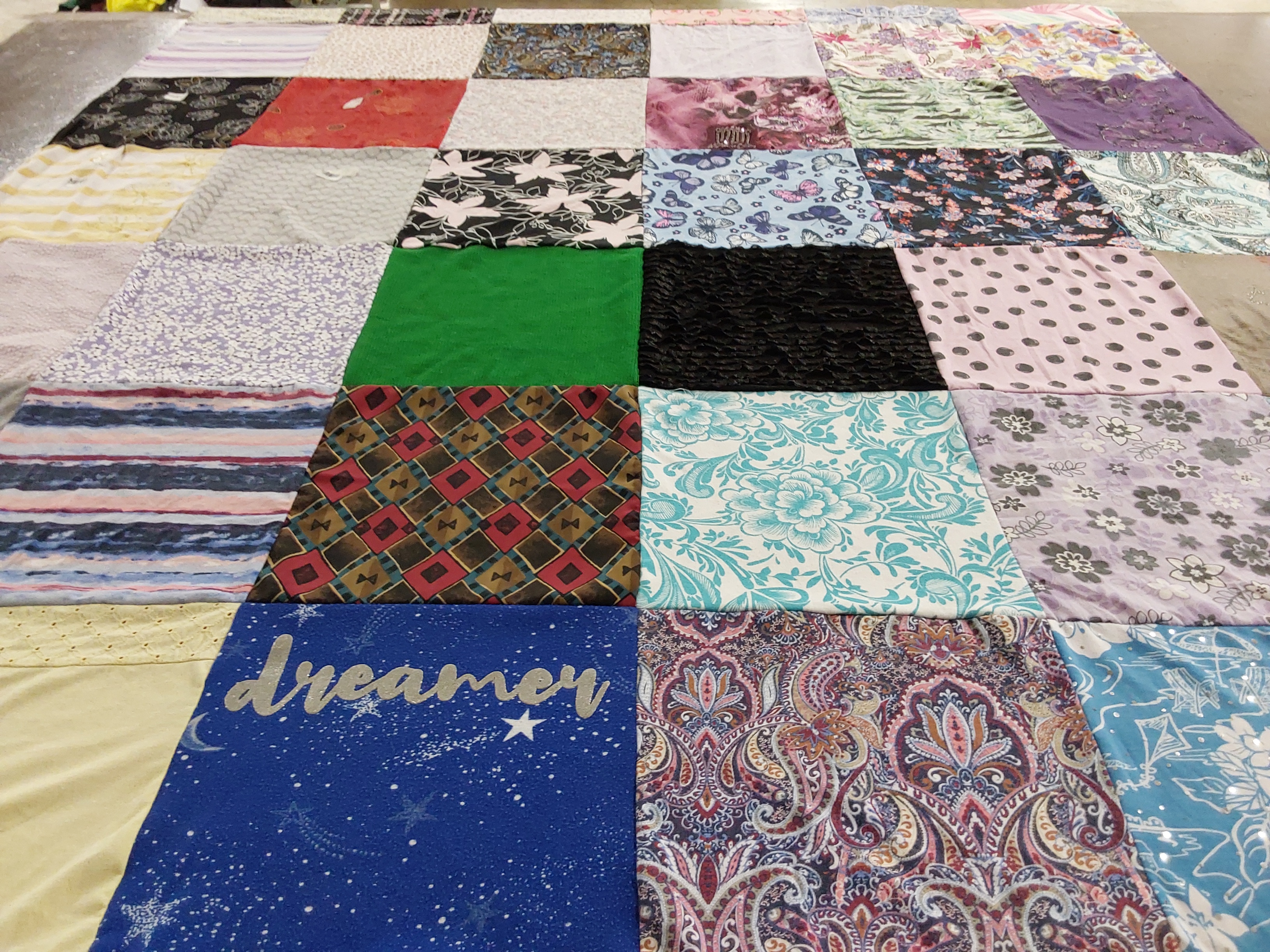 Custom Project Repat t-shirt quilt made from shirts with text like “dreamer”.