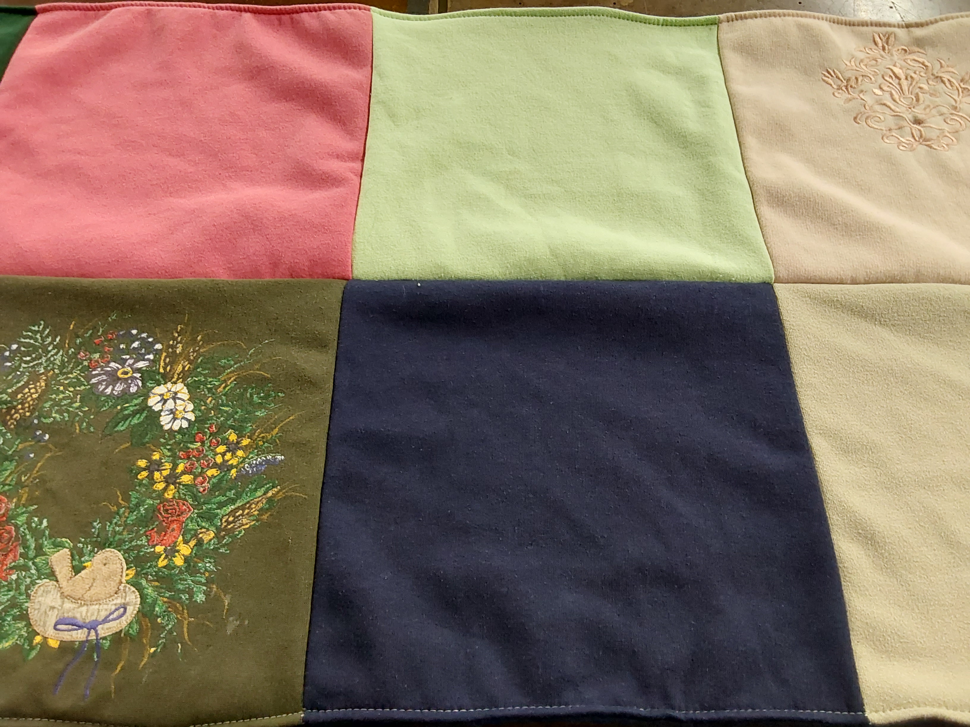 Custom Project Repat t-shirt quilt highlighting embroidery, gardening themes.